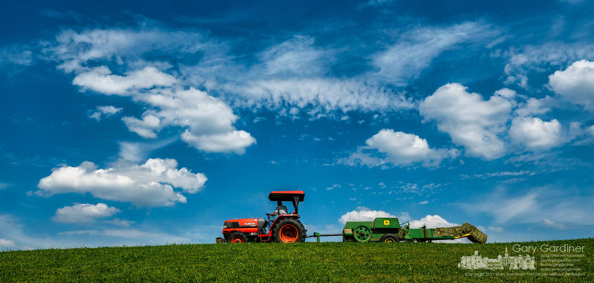 Duane Yarnell bales hay along the edge of the hill at the rear of his farm on Africa Road. My Final Photo for May 25, 2021.