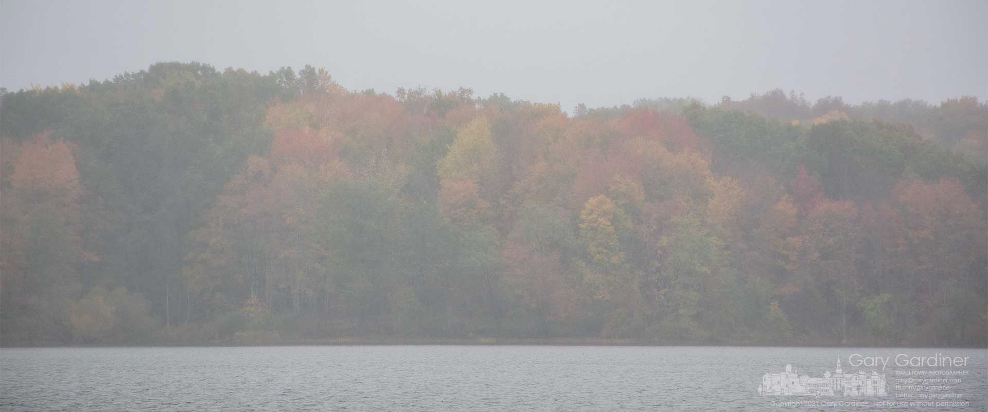 A rain squall obscures the eastern shore of Hoover Reservoir where trees are beginning to show their full set of fall colors. My Final Photo for Oct. 29, 2021.