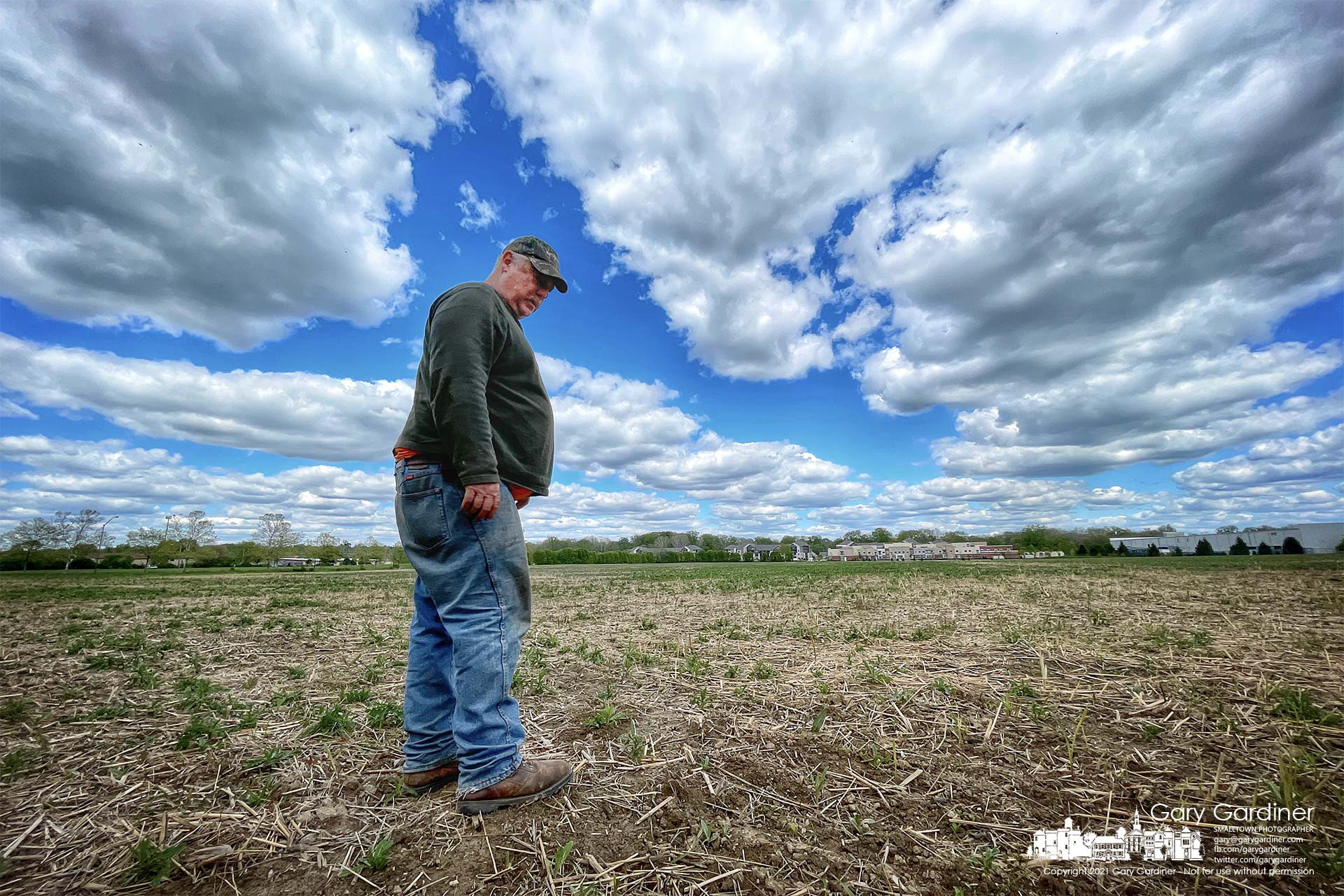 Kevin Scott surveys the Spring growth of weeds and the progress of the soybean seeds he planted two weeks ago on the fields at the Braun Farm. My Final Photo for May 12, 2021.