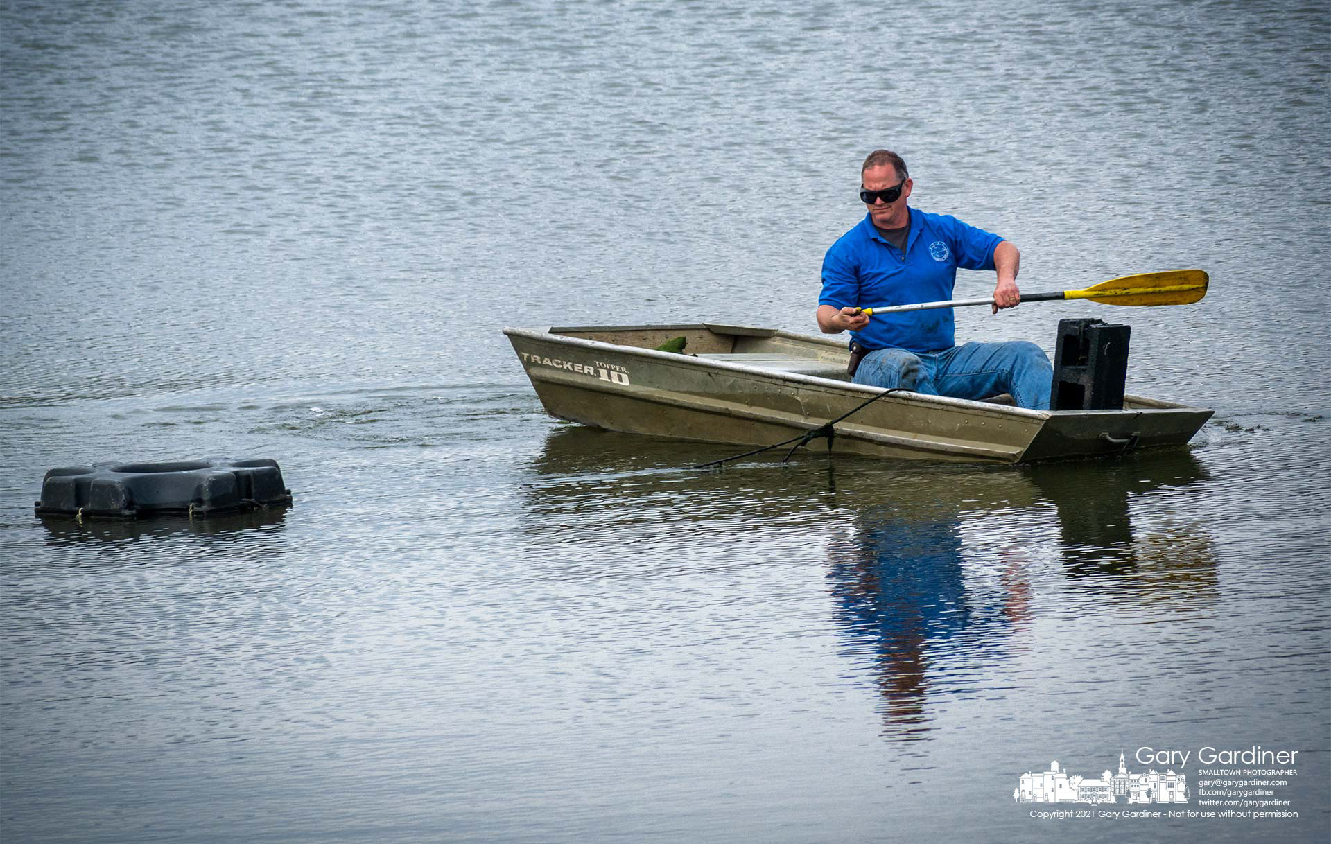 A city parks worker installs one of the pumps for the fountains at the pond at Hoff Woods Park. My Final Photo for March 23, 3021.