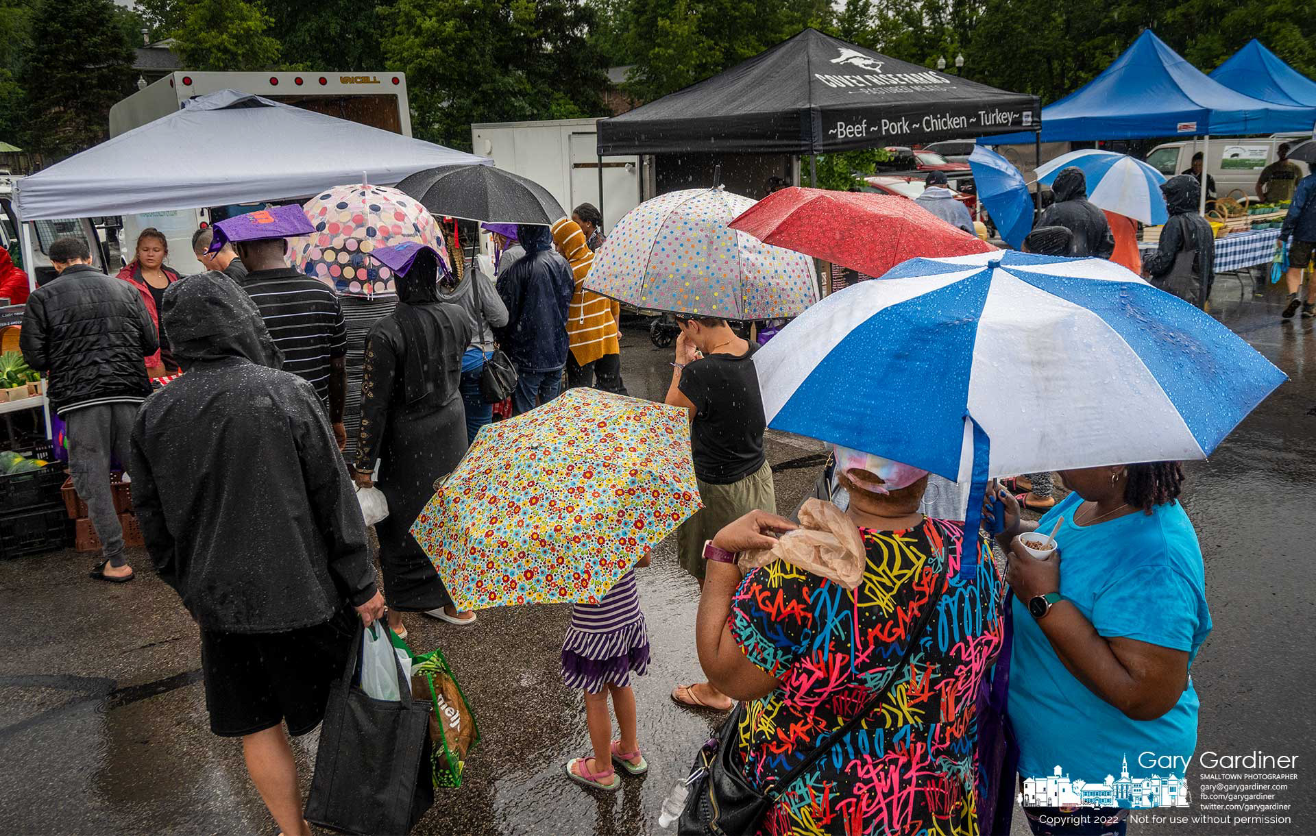A collection of umbrellas shields shoppers at the Saturday Market in Uptown Westerville with most of the morning covered with rain clouds that kept the lines shorter. My Final Photo for July 16, 2022.