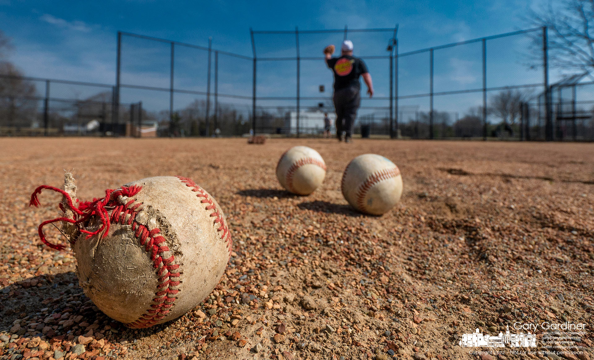 A ragged and torn baseball is one of the baseballs this father uses to begin Spring training on the fields at Huber Village Park on the first spring-like day of the year. My Final Photo for March 5, 2022.