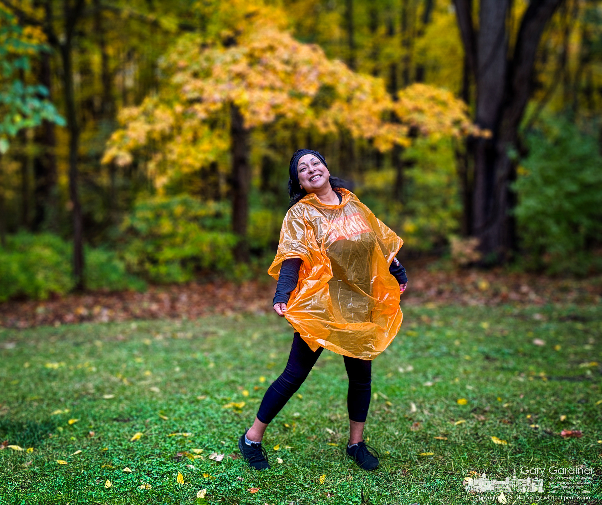 Jackie, the mother of a third-grader on a field trip to Inniswood, laughs as she shows off the pumpkin-colored rain poncho she wears that she is convinced embarrassed her child. My Final Photo for October 20, 2023.  https://bit.ly/45DYcS7