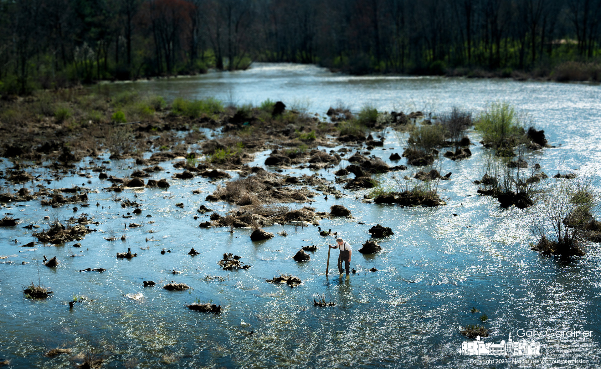 A fisherman searches below Hoover Dam for saugeye hidden in the shallows where he grabs them by their gills instead of casting a line with traditional bait. My Final Photo for April 9, 2023.