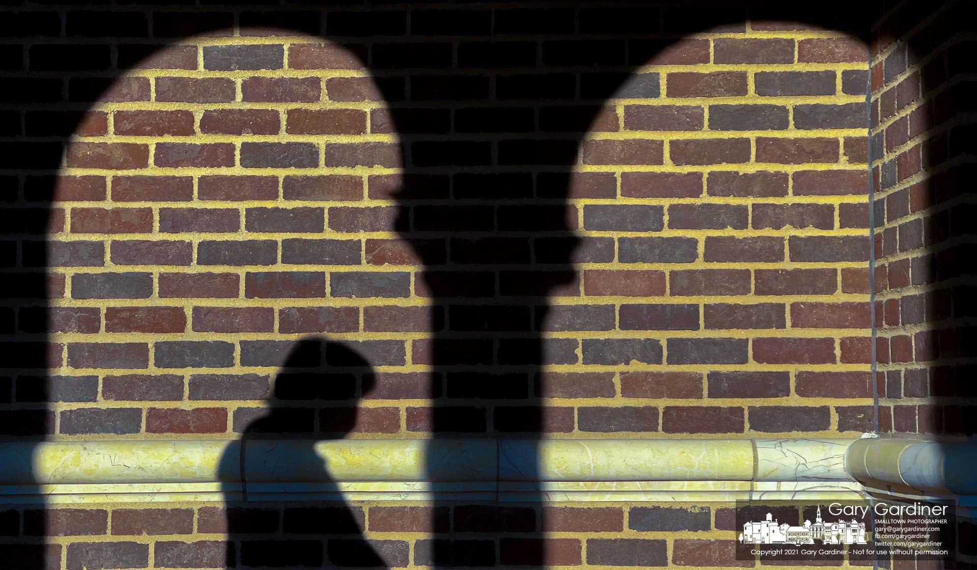 A parishioner's shadow settles on a wall leading into St. Paul the Apostle Catholic Church. My Final Photo for March 7, 2021.