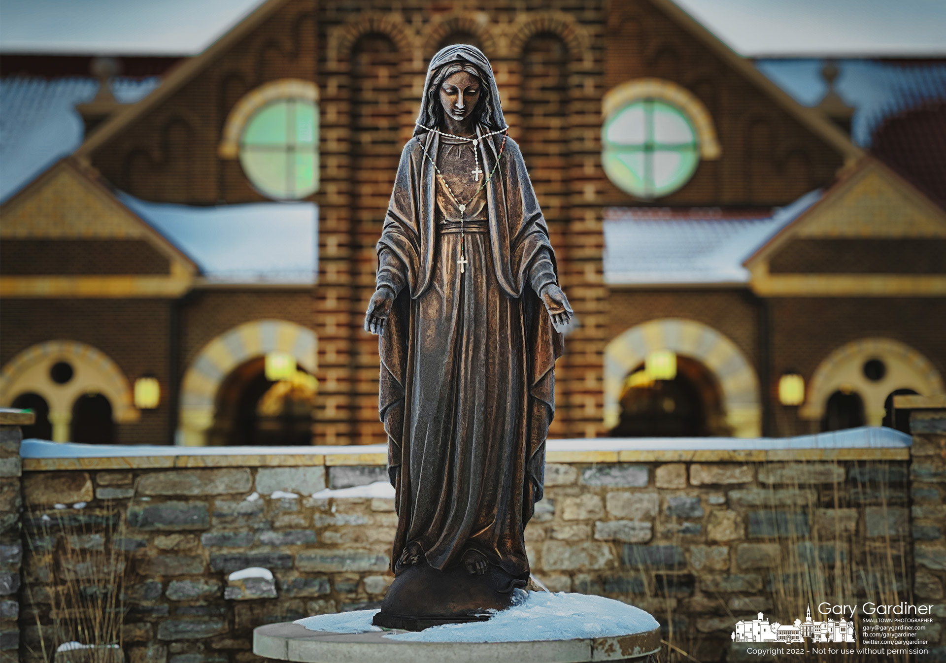 The statue of Mary wears a pair of rosaries and a layer of frost just minutes after sunrise on Sunday morning before the first Mass. My Final Photo for February 6, 2022.