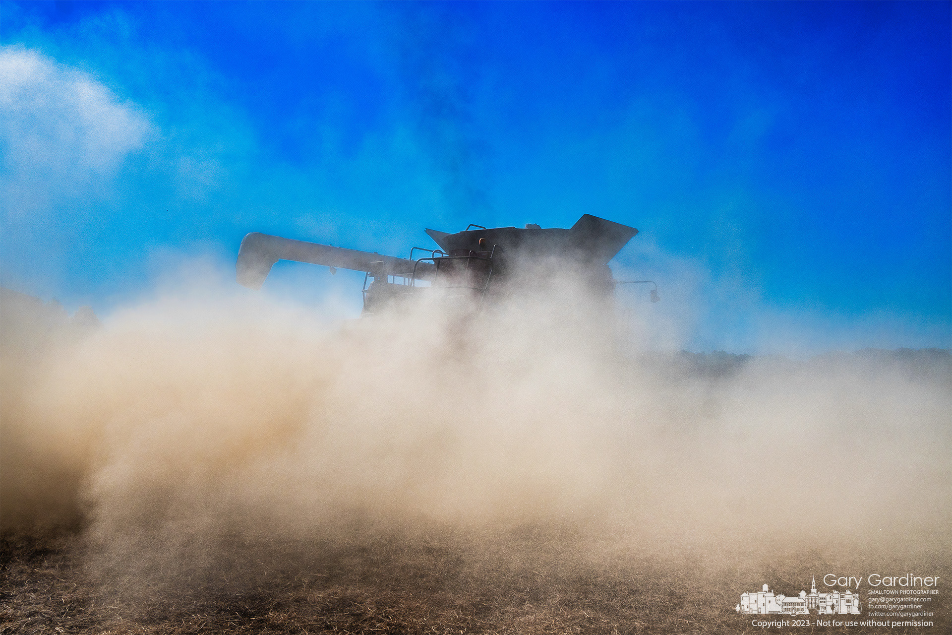 A dust cloud from harvesting soybeans envelops the combine working the lower field on the Yarnell Farm in Westerville. My Final Photo for October 23, 2023. https://bit.ly/46ZgRc8