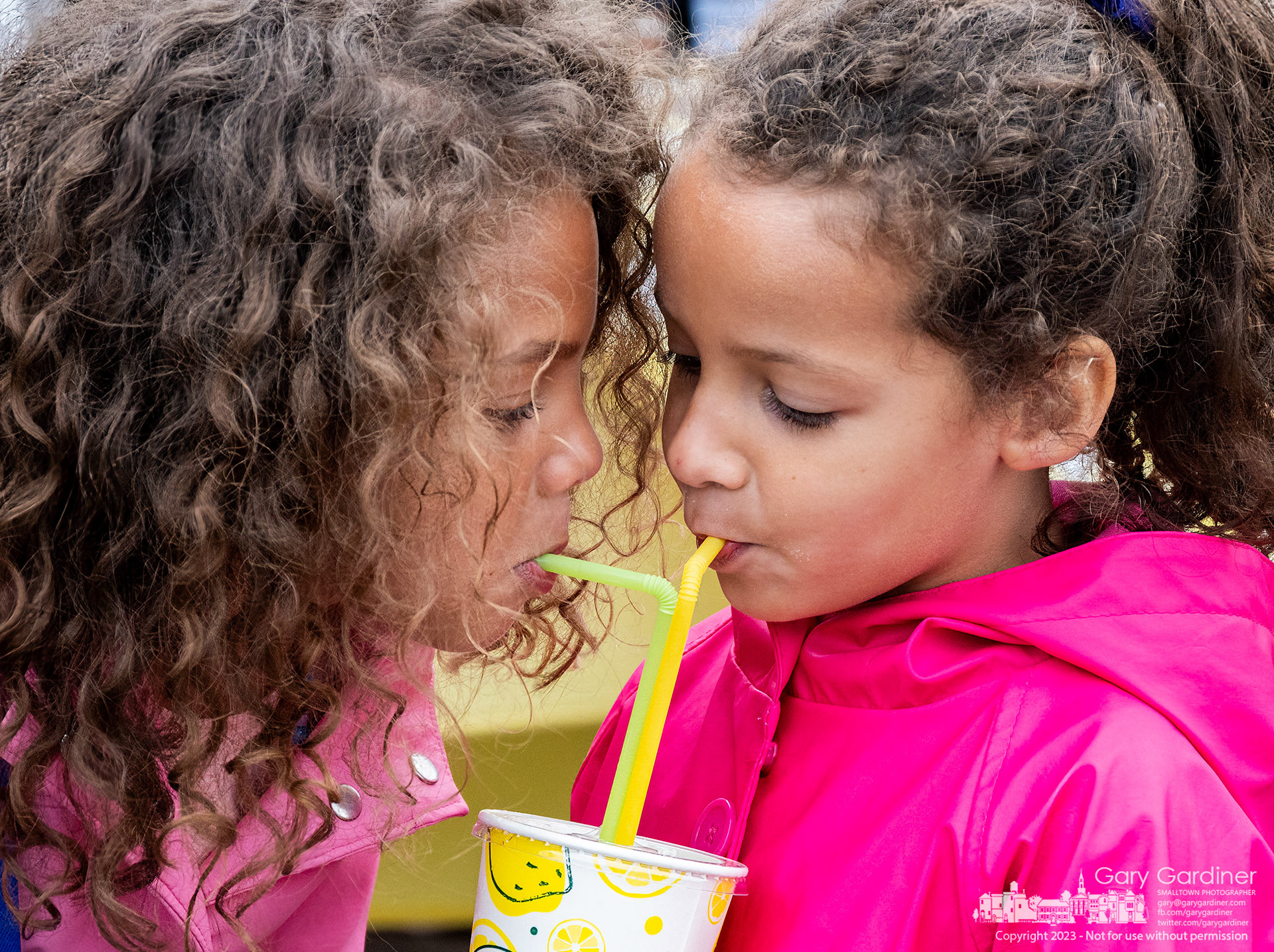 Sisters share a fresh-made lemonade during a break in shopping at the Uptown Westerville Saturday Farmers Market on its opening day for the season. My Final Photo for May 20, 2023. 