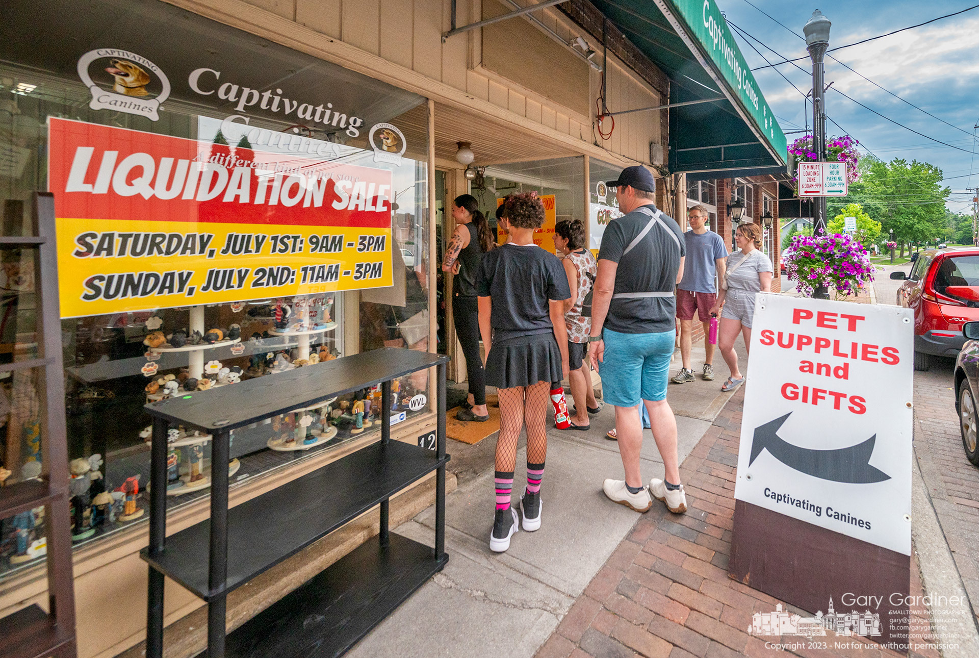 Customers line up to enter Captivating Canines on the first day of a liquidation sale after the store's owner, Ron Keller, died earlier this year. My Final Photo for July 1, 2023. 