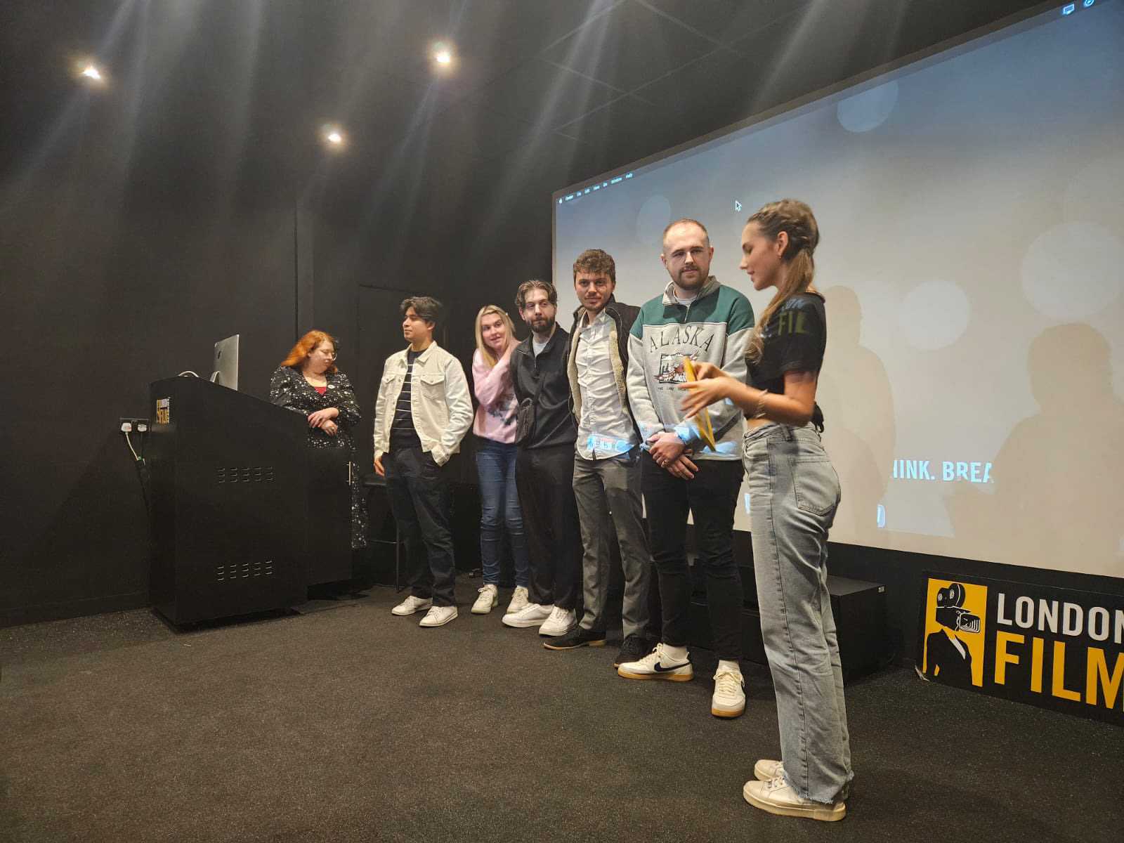 The winning team behind one of the selected films speaking in front of the cinema screen at BUZZIN’ SHORTS 2024