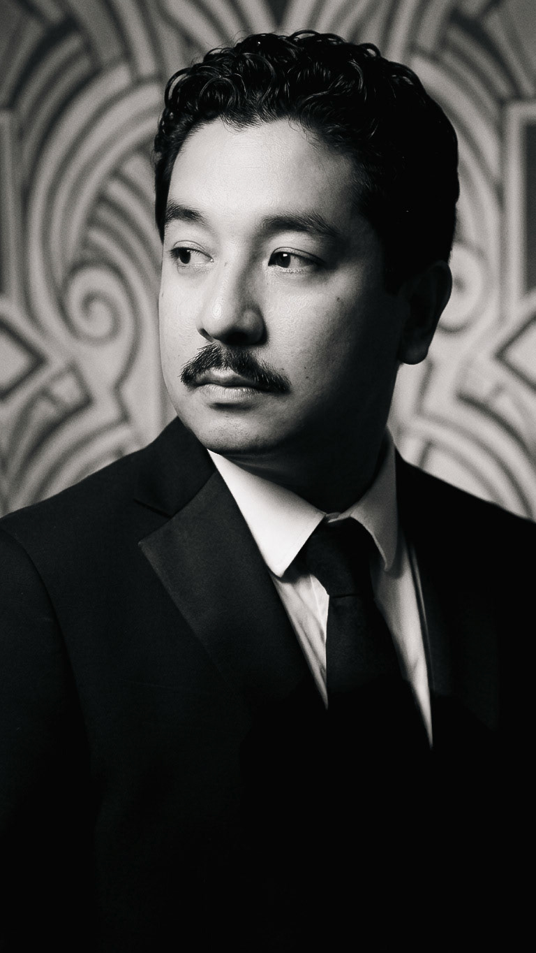 Jonah Rivera • Tailored Art Deco style, mid-century professional attire, classic Hollywood lounge aesthetic, modern noir fashion.