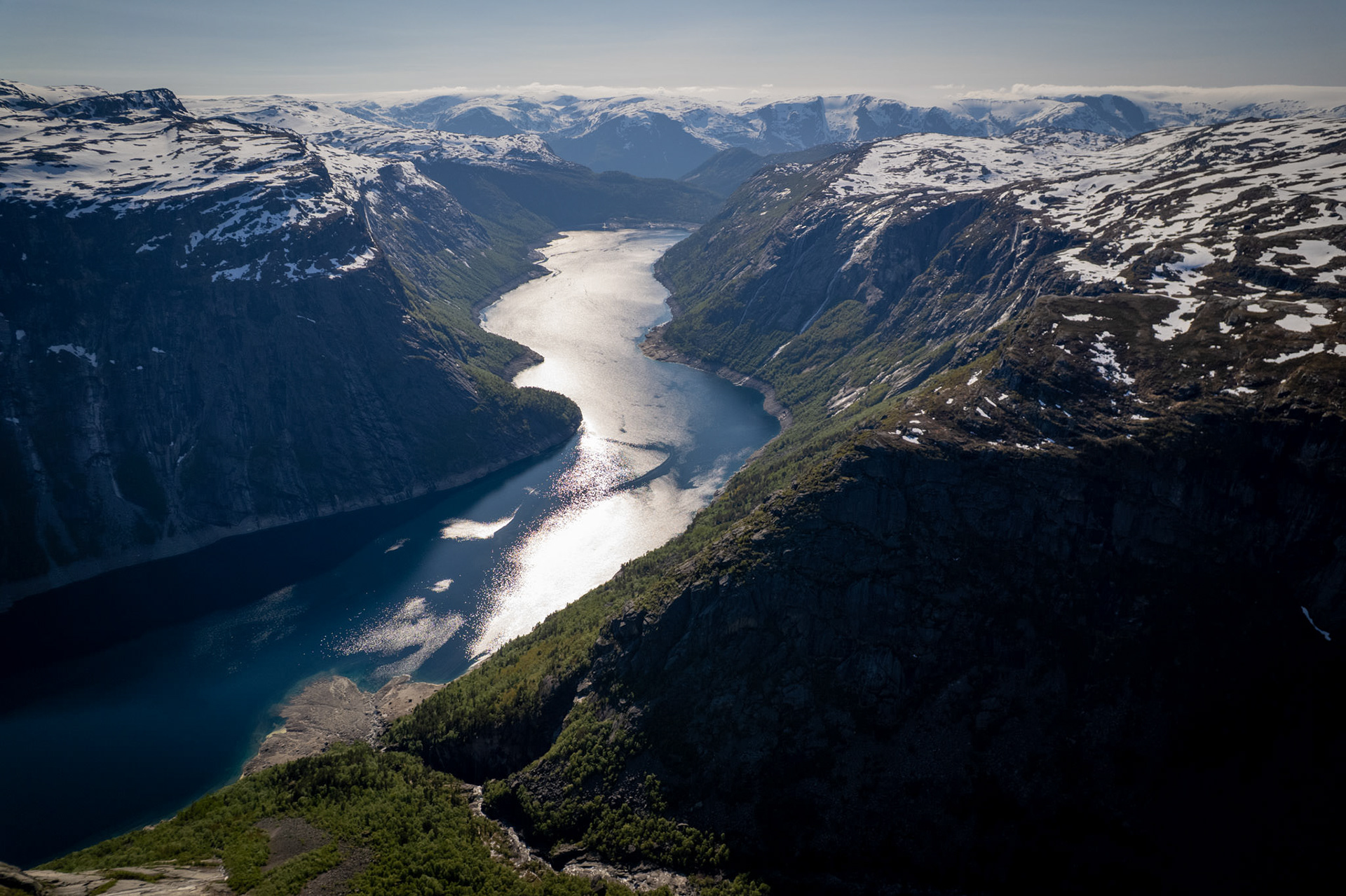 Norwegian Fjord View – Majestic aerial view over snow-capped fjords and winding water channels in Norway.