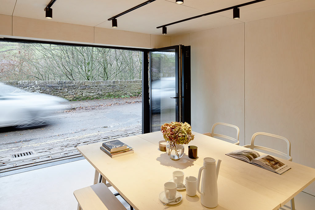 floor-to-ceiling doors open to connect with the street