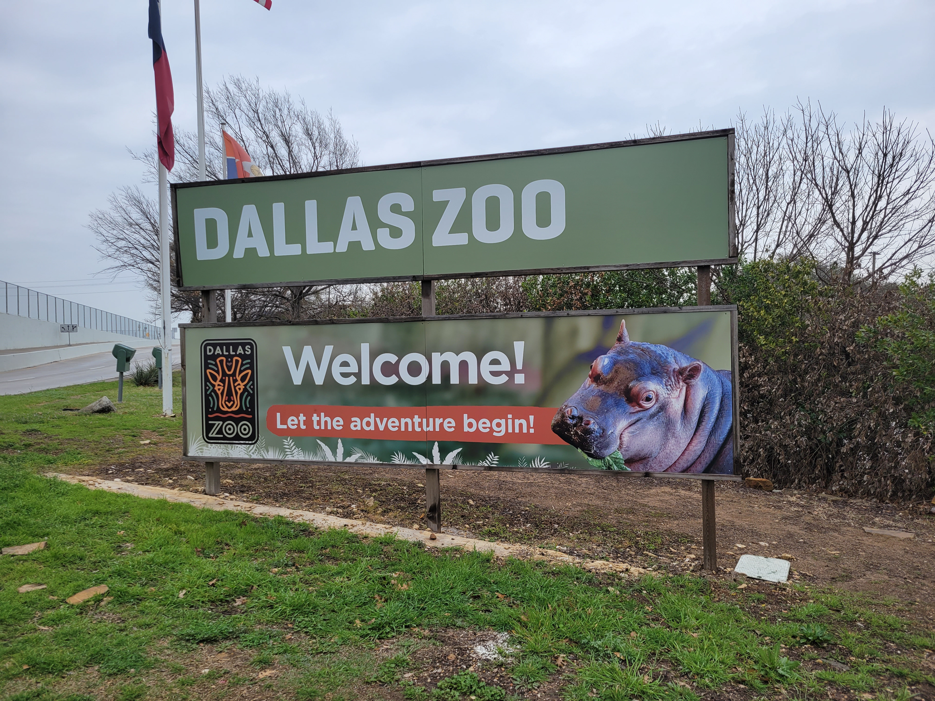 Front entry welcome board featuring one of the newest animals born at the Zoo