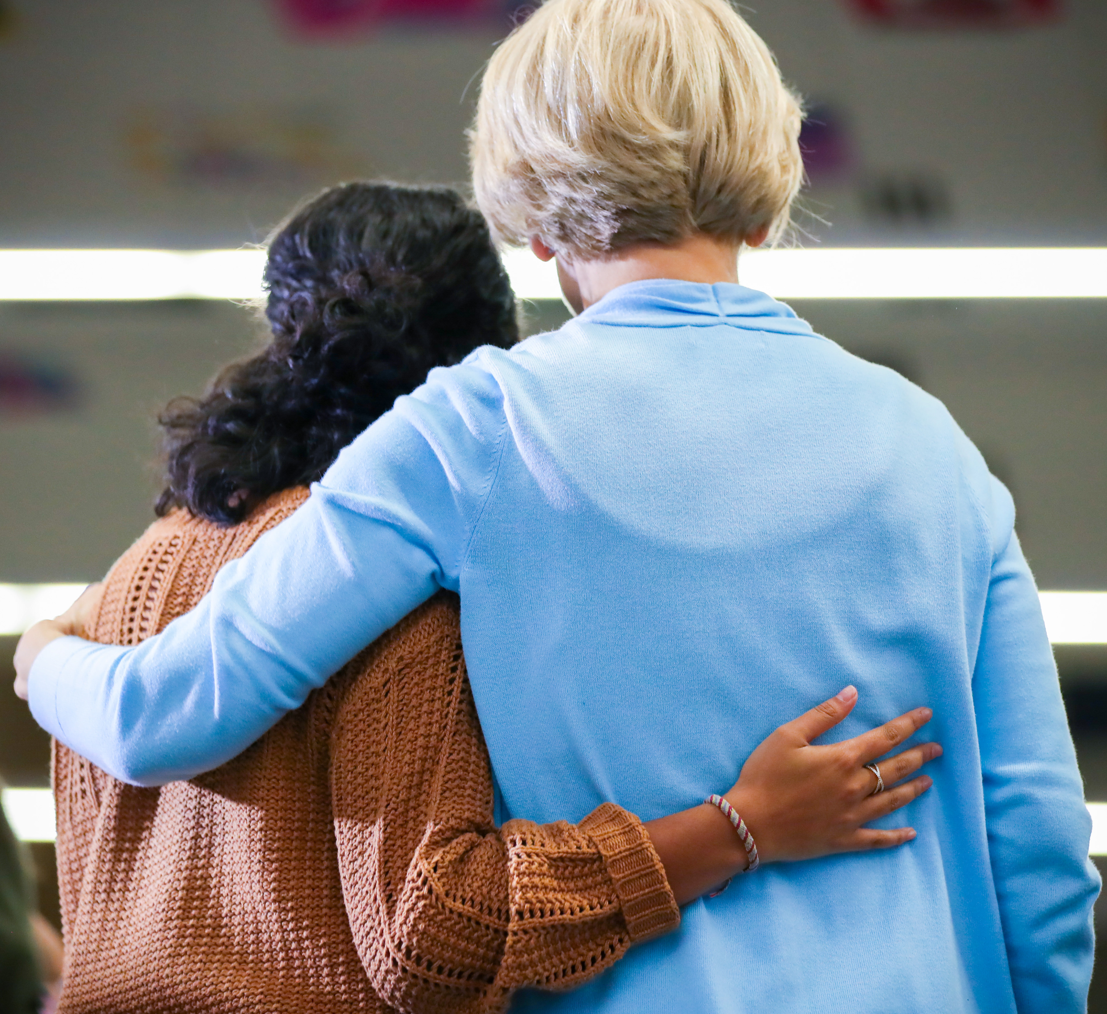 Senator Elizabeth Warren and a young female supporter put their arms around each other for a photograph following a town hall event on January 11, 2020 at the Lincoln Intermediate School in Mason City, Iowa.