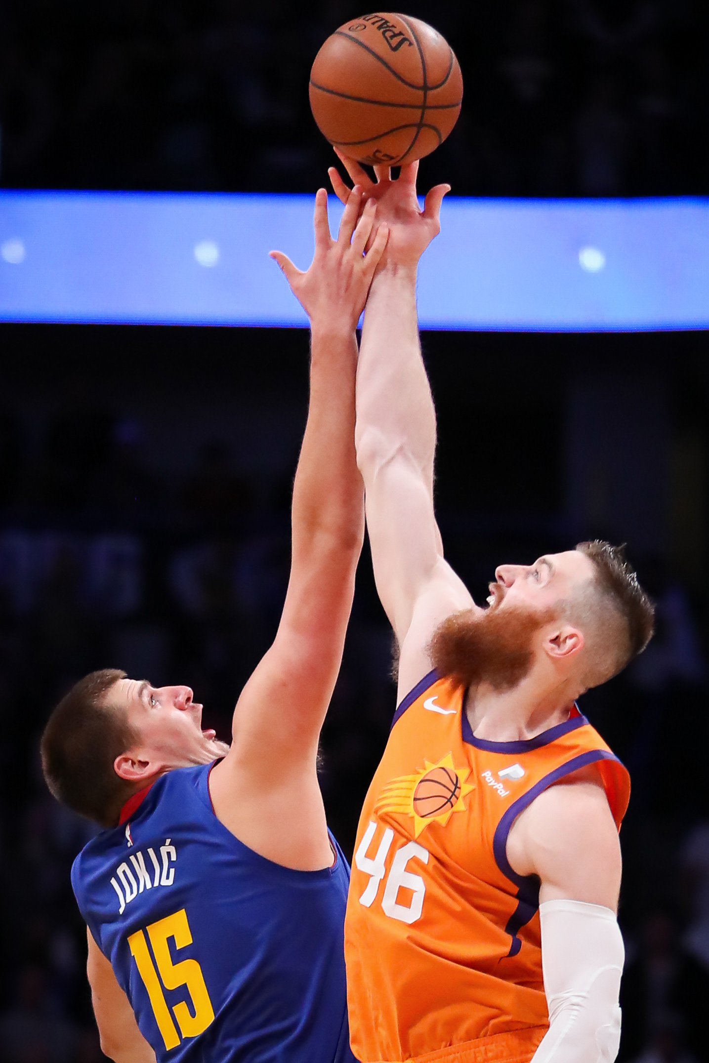 Aron Baynes #46 of the Phoenix Suns wins the tip off against Nikola Jokić #15 of the Denver Nuggets during the season homer at Pepsi Center on October 25, 2019 in Denver, Colorado.