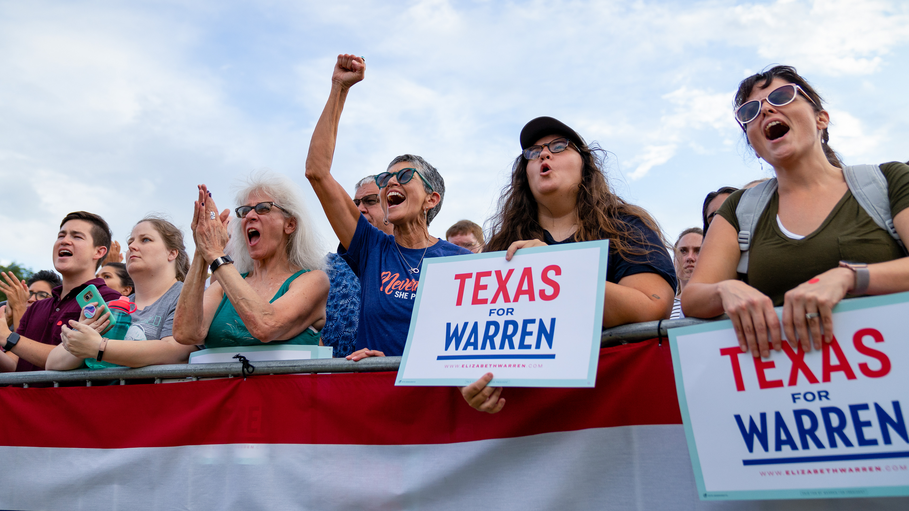 Supporters of Senator Elizabeth Warren smiles on cheer in response to her proposal of a 2 Cent Tax plan during a town hall event on September 10, 2019 at Auditorium Shores in Austin, Texas.