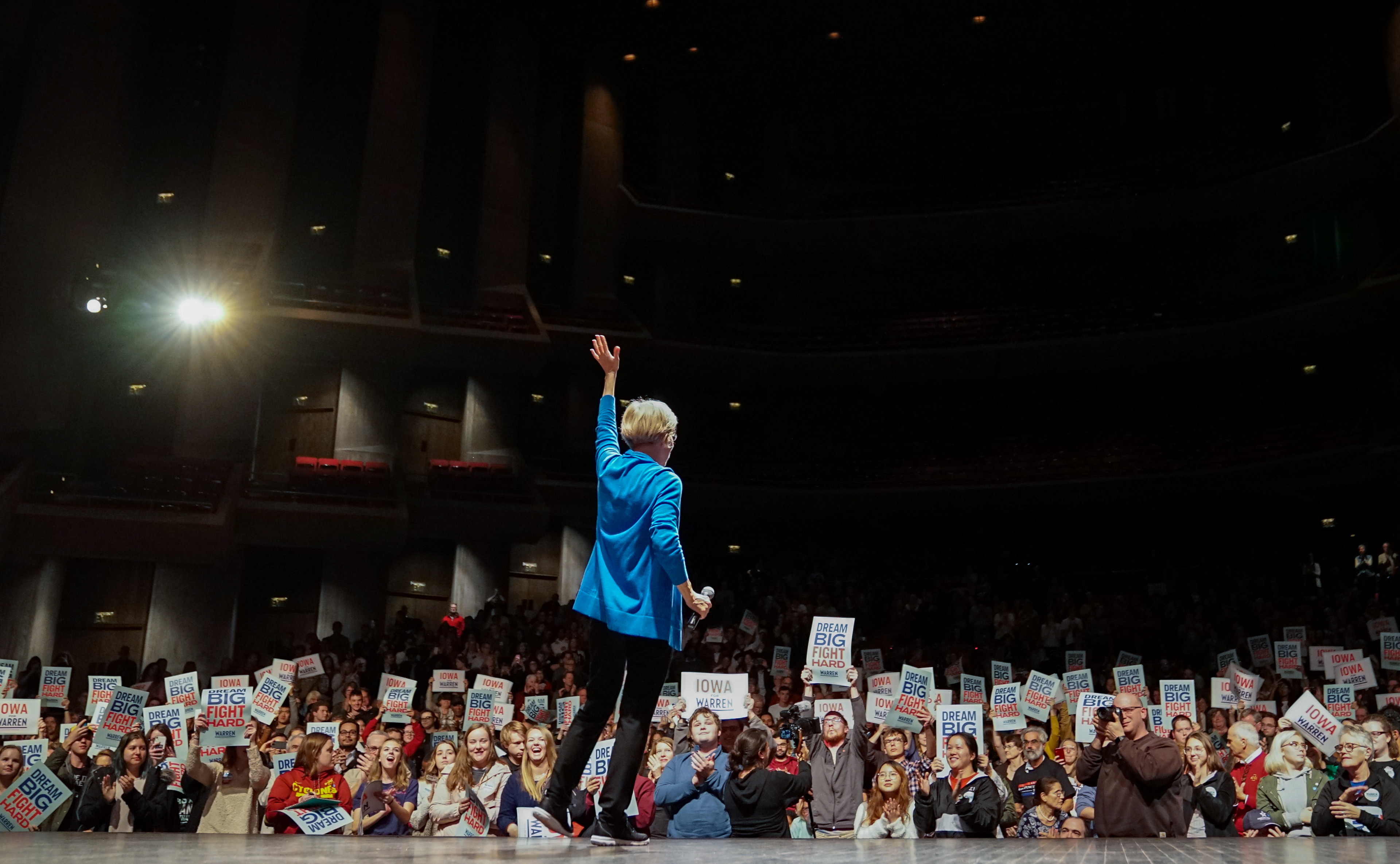 Senator Elizabeth Warren waves to a cheering crowd during a town hall event on October 21, 2019 at Iowa State University in Ames, Iowa.