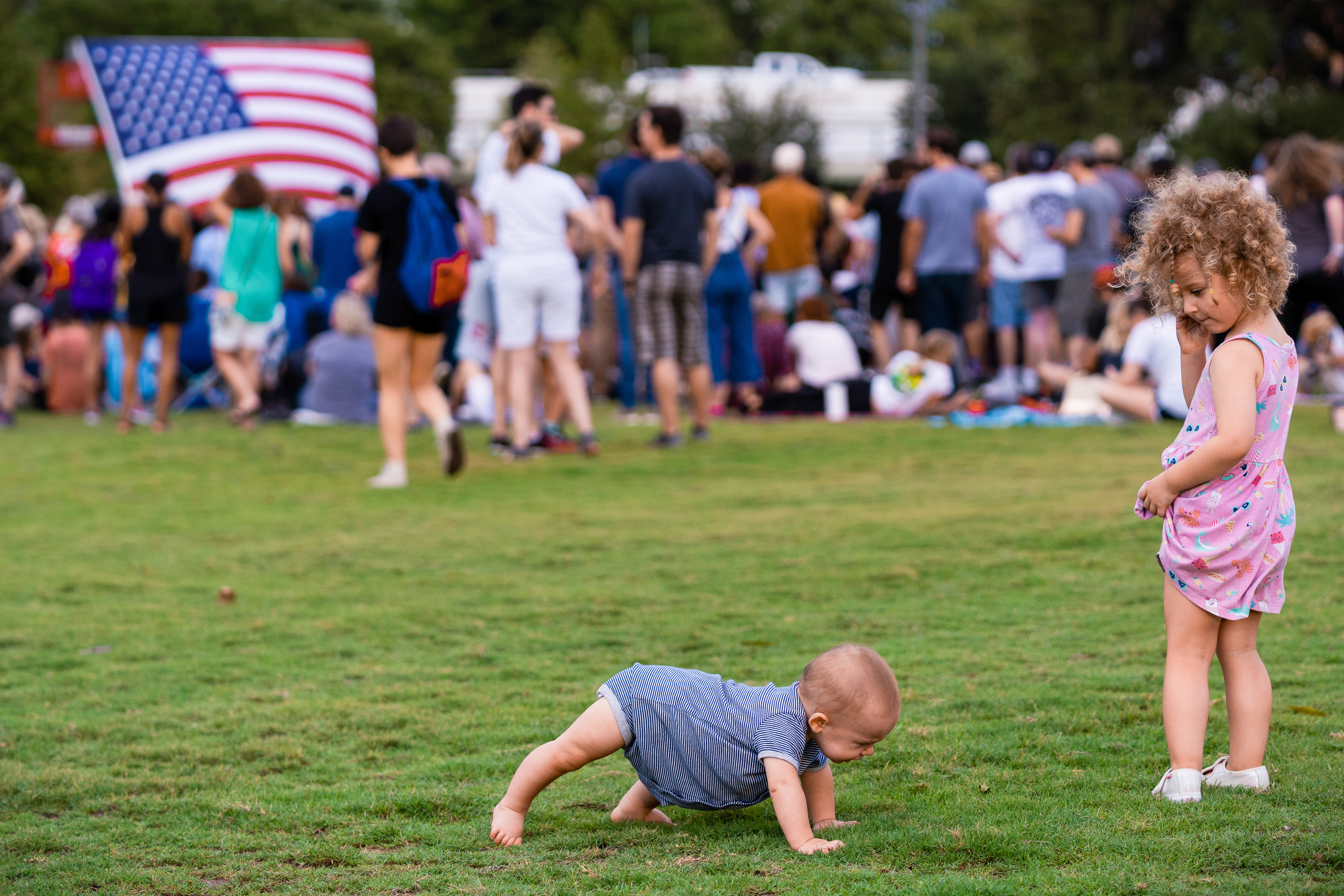 Two children play on the lawn prior to an Elizabeth Warren for President 2020 town hall event on September 10, 2019 at Auditorium Shores in Austin, Texas.