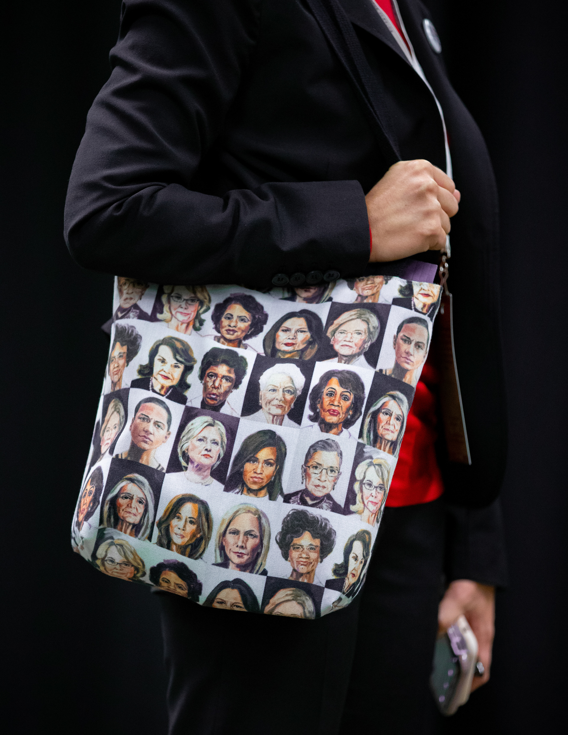A supporter of Senator Elizabeth Warren carries a bag adorned with the faces of feminist icons during the Massachusetts Democratic Convention held at the Mass Mutual Center on September 14, 2019 in Springfield, Massachusetts.