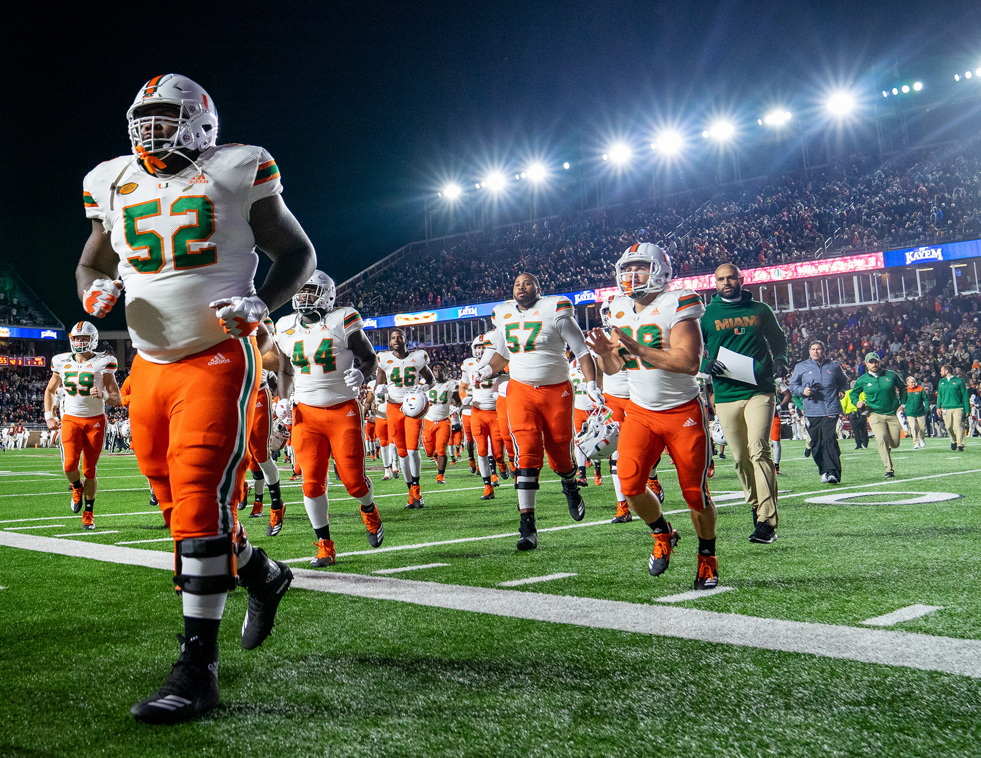 Members of the University of Miami Hurricanes leave the field during halftime of the annual Red Bandana game against the Boston College Eagles on October 26, 2018 at Alumni Stadium in Boston, Massachusetts. The Eagles defeated the Hurricanes 27-14.