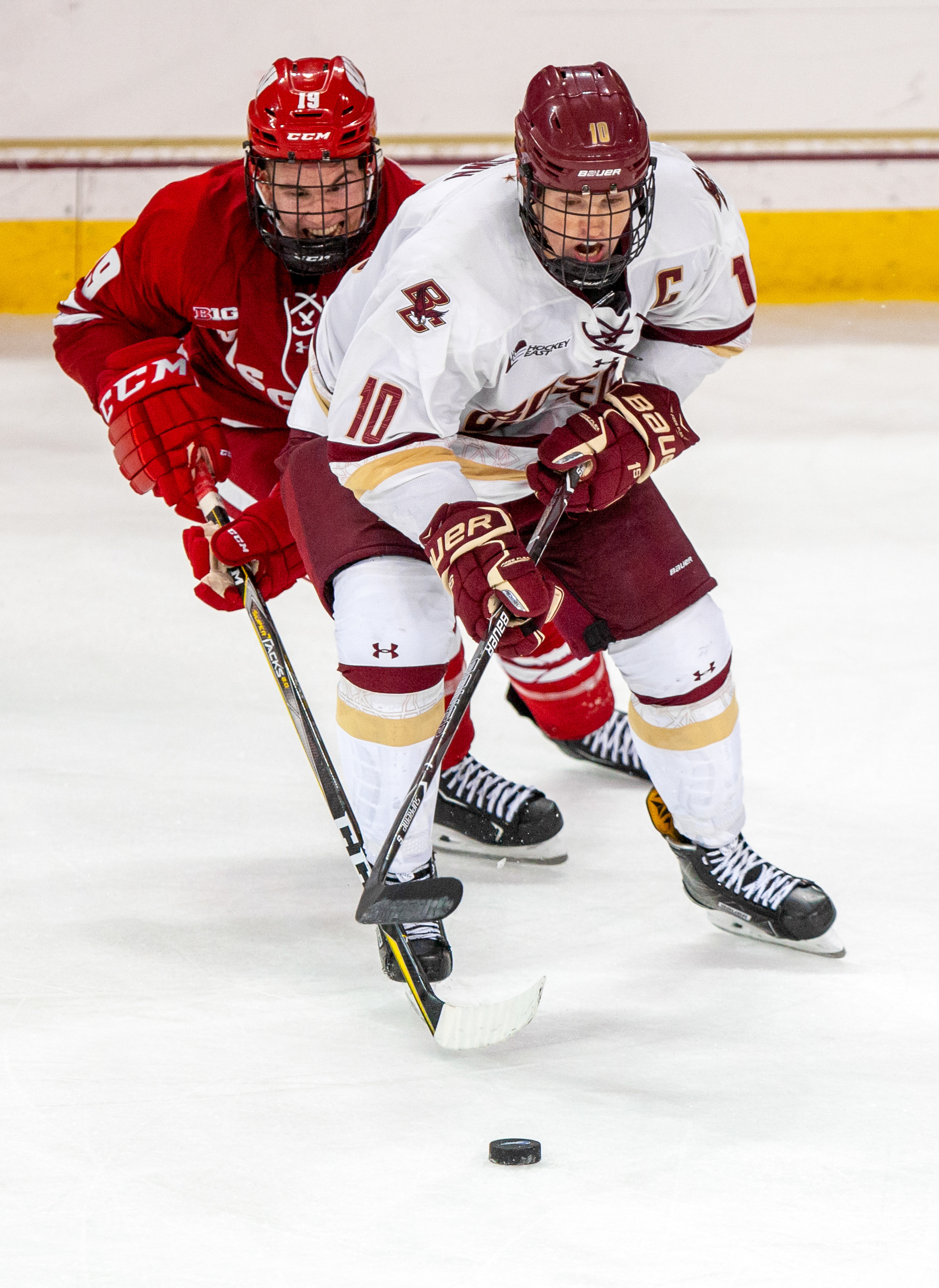 Christopher Brown #10 of the Boston College Eagles battles with Cameron Hughes #19 of the University of Wisconsin Badgers during the third period of a game at Conte Forum in Boston, Massachusetts on October 13, 2017. The Bagers defeated the Eagles 5-2.