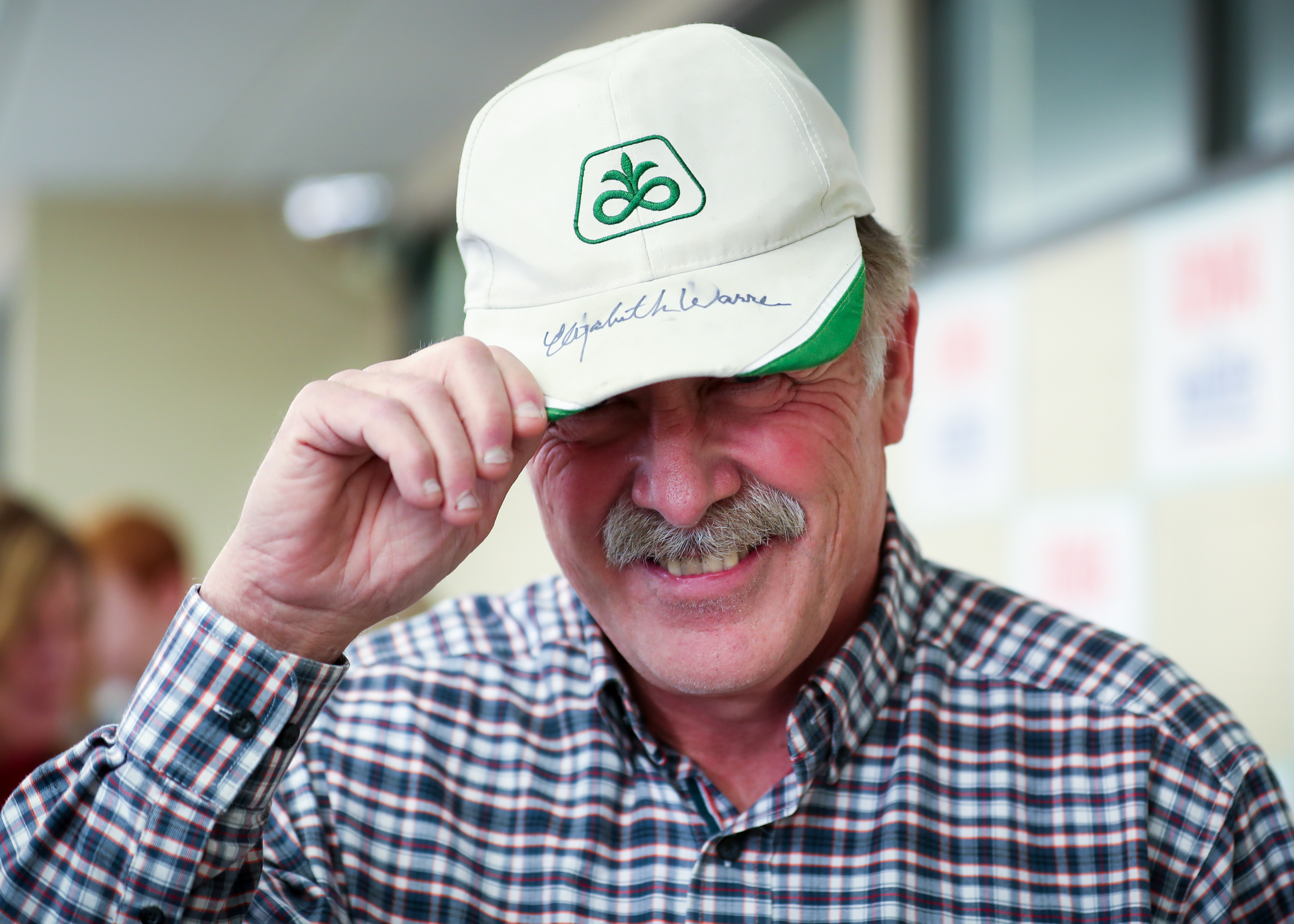 A supporter of Senator Elizabeth Warren smiles after getting his hat signed prior to a town hall event on January 11, 2020 at the Lincoln Intermediate School in Mason City, Iowa.