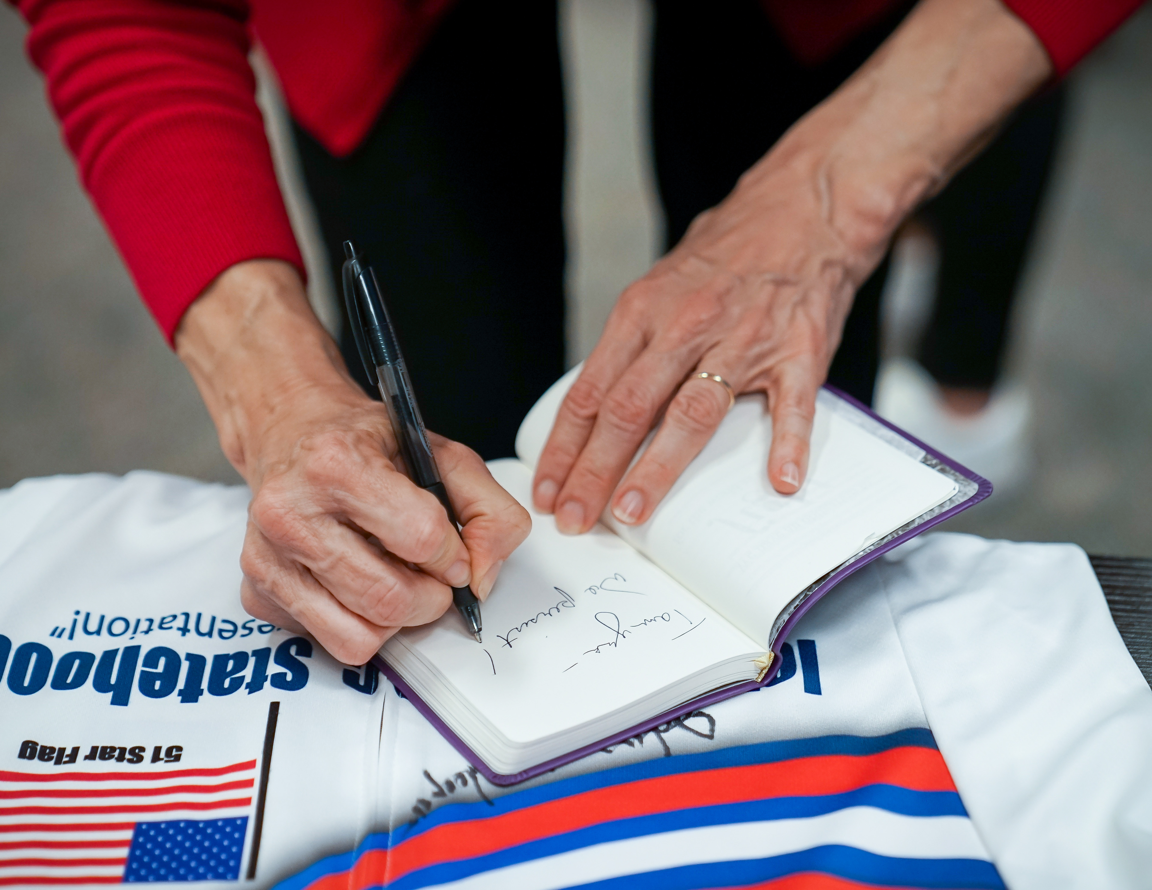 Senator Elizabeth Warren signs the journal of a local supporter prior to a town hall event on October 20, 2019 at Simpson College in Indianola, Iowa.