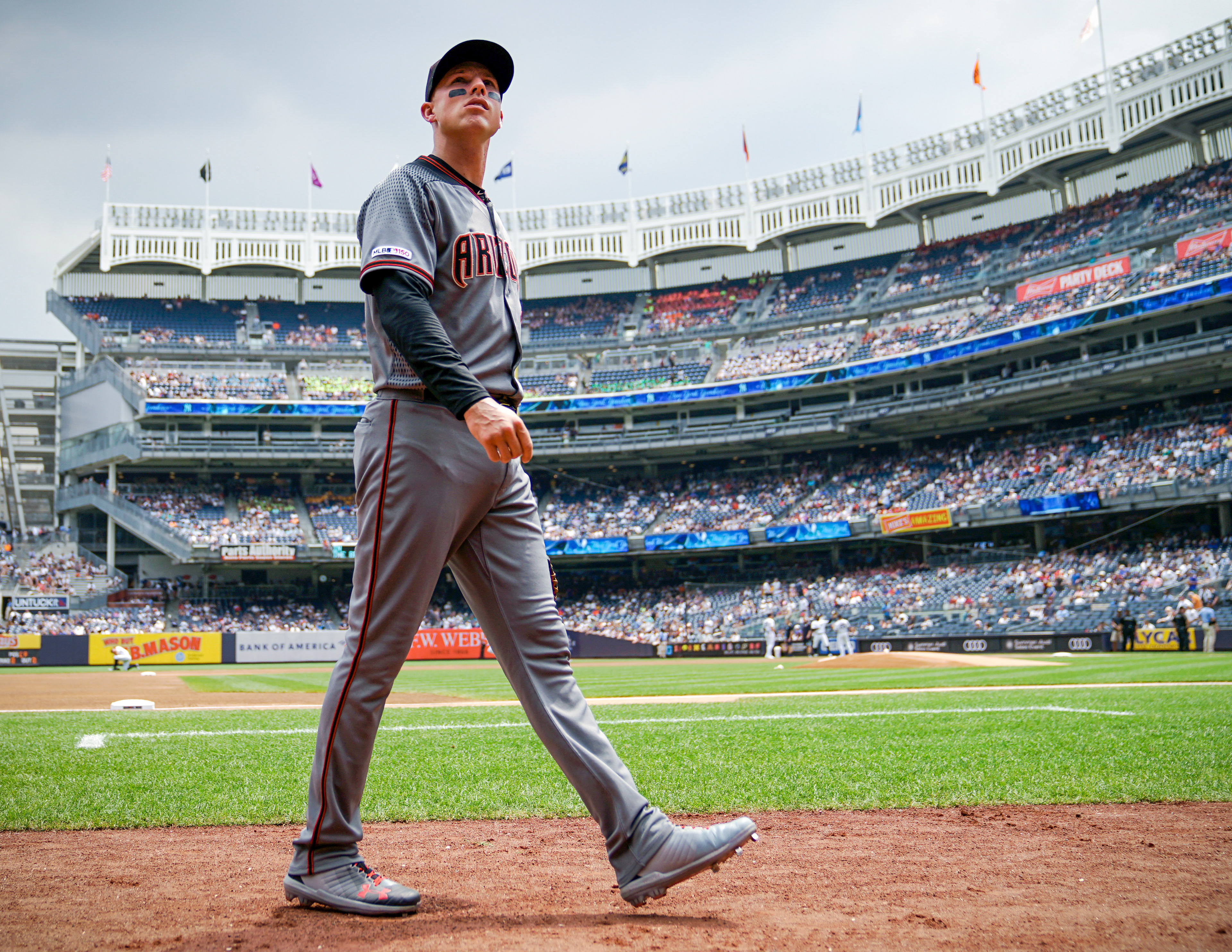 Jake Lamb #22 of the Arizona Diamondbacks returns to the dugout prior to a game between the Arizona Diamondbacks and the New York Yankees at Yankee Stadium on Wednesday, July 31, 2019 in the Bronx borough of New York City.