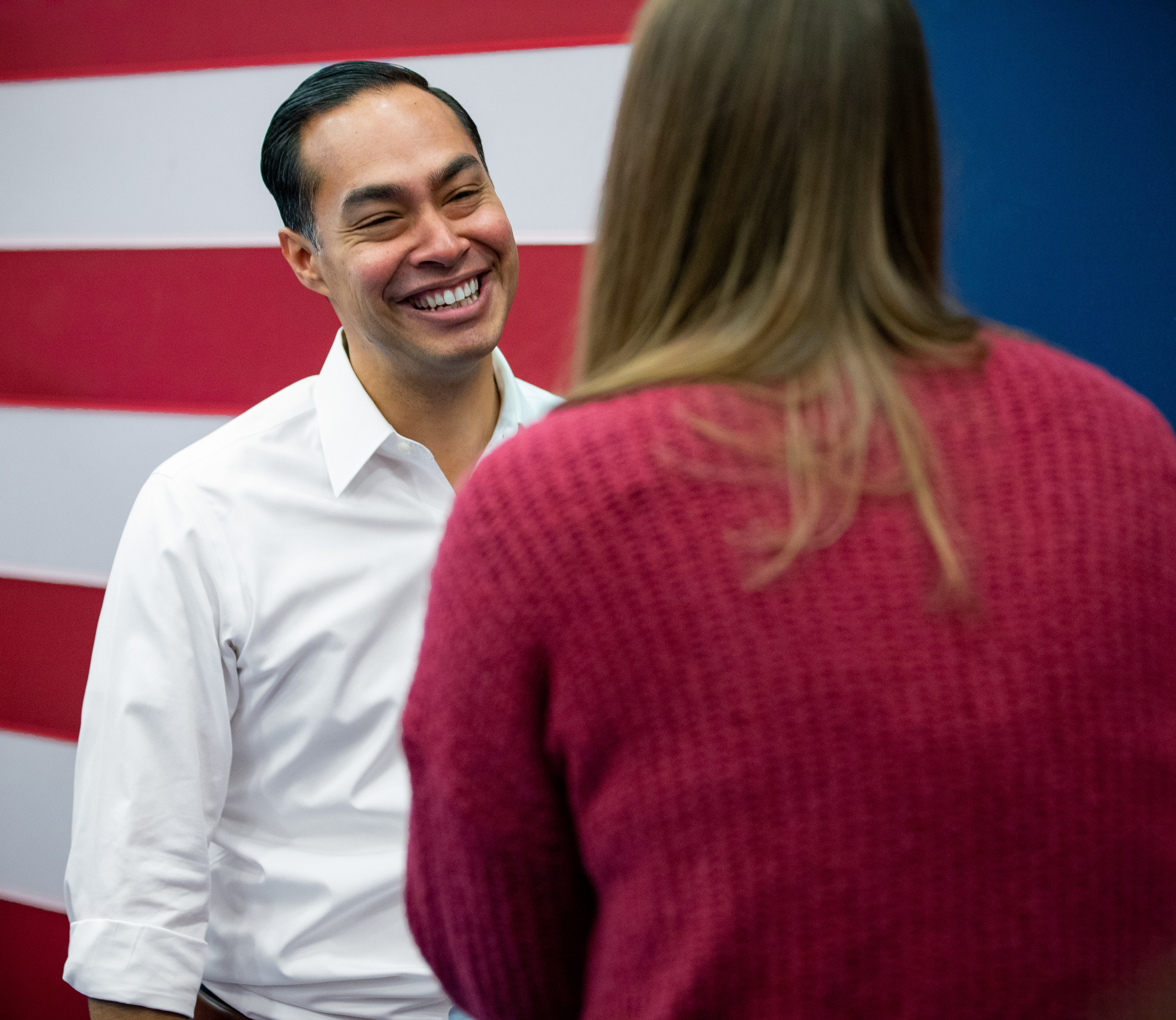 Secretary Julián Castro laughs alongside a supporter of Sentaor Elizabeth Warren prior to a town hall event on January 12, 2020 at Fisher Elementary School in Marshalltown, Iowa.