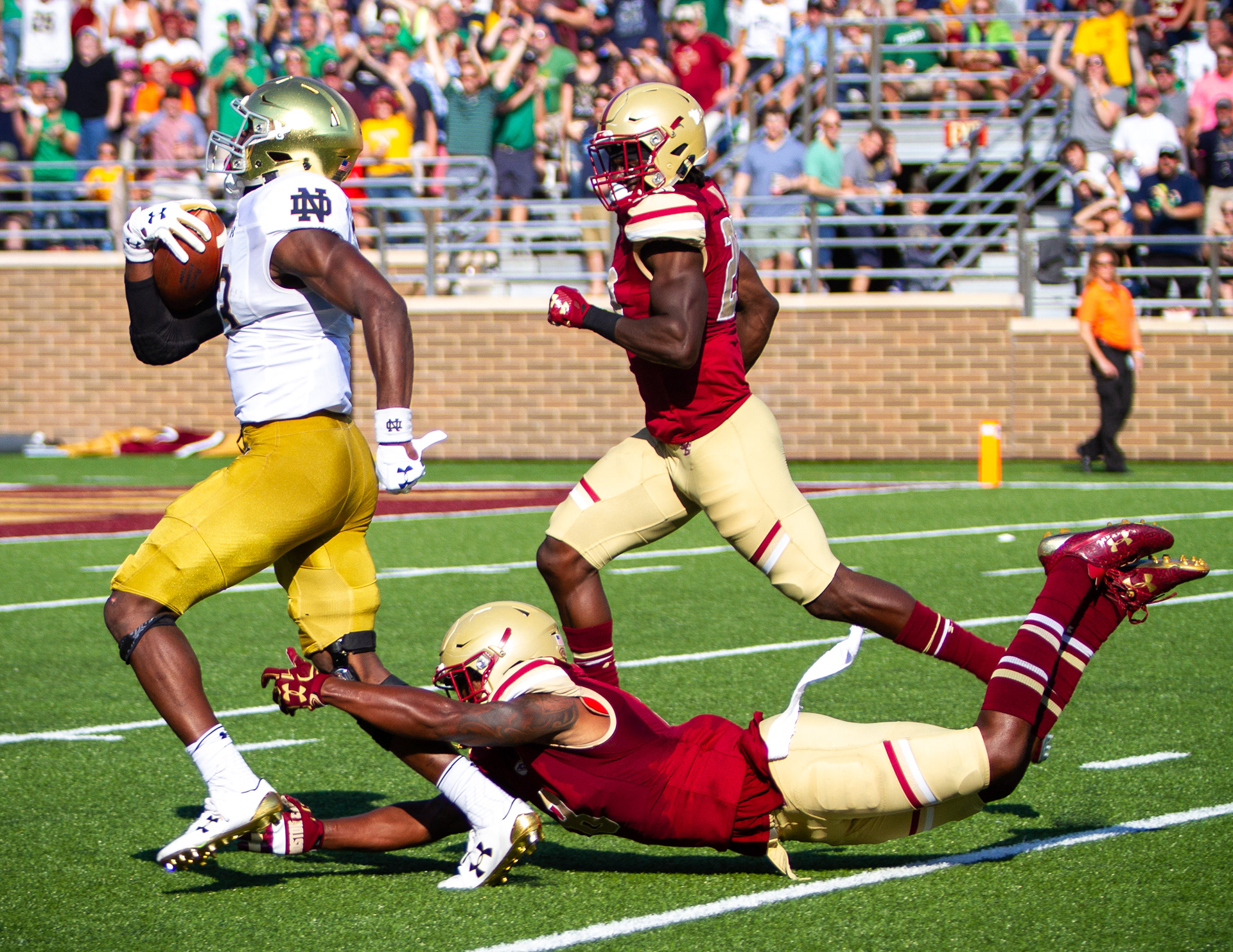 Two members of the Boston College Eagles attempt to stop a member of the Notre Dame Fighting Irish from scoring on September 16, 2017 at Alumni Stadium in Boston, Massachusetts. The Fighting Irish defeated the Eagles 49-20.