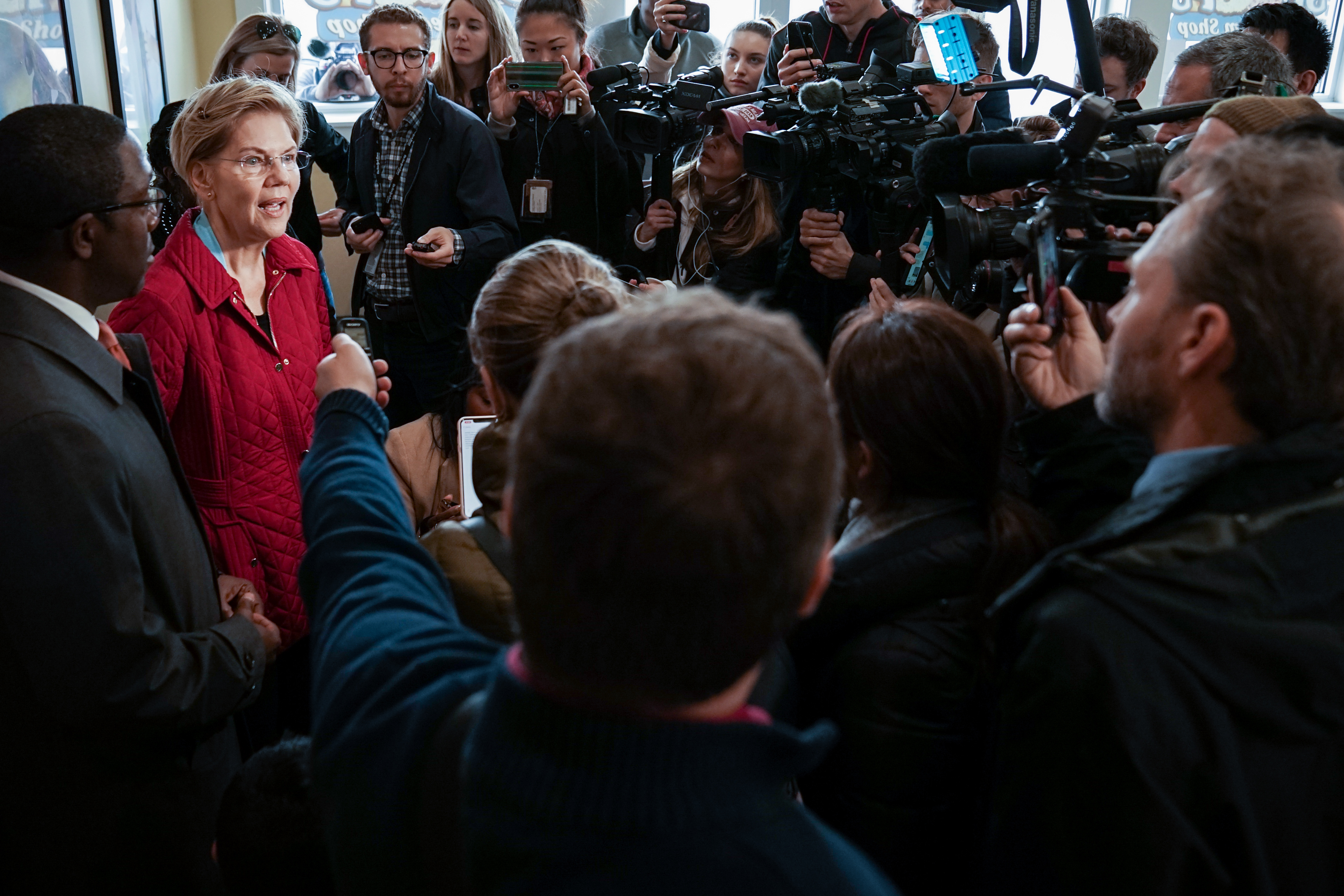 Senator Elizabeth Warren responds to press questions at Two Scoops Ice Cream Shop during her walking tour on October 22, 2019 in Waterloo, Iowa. 
