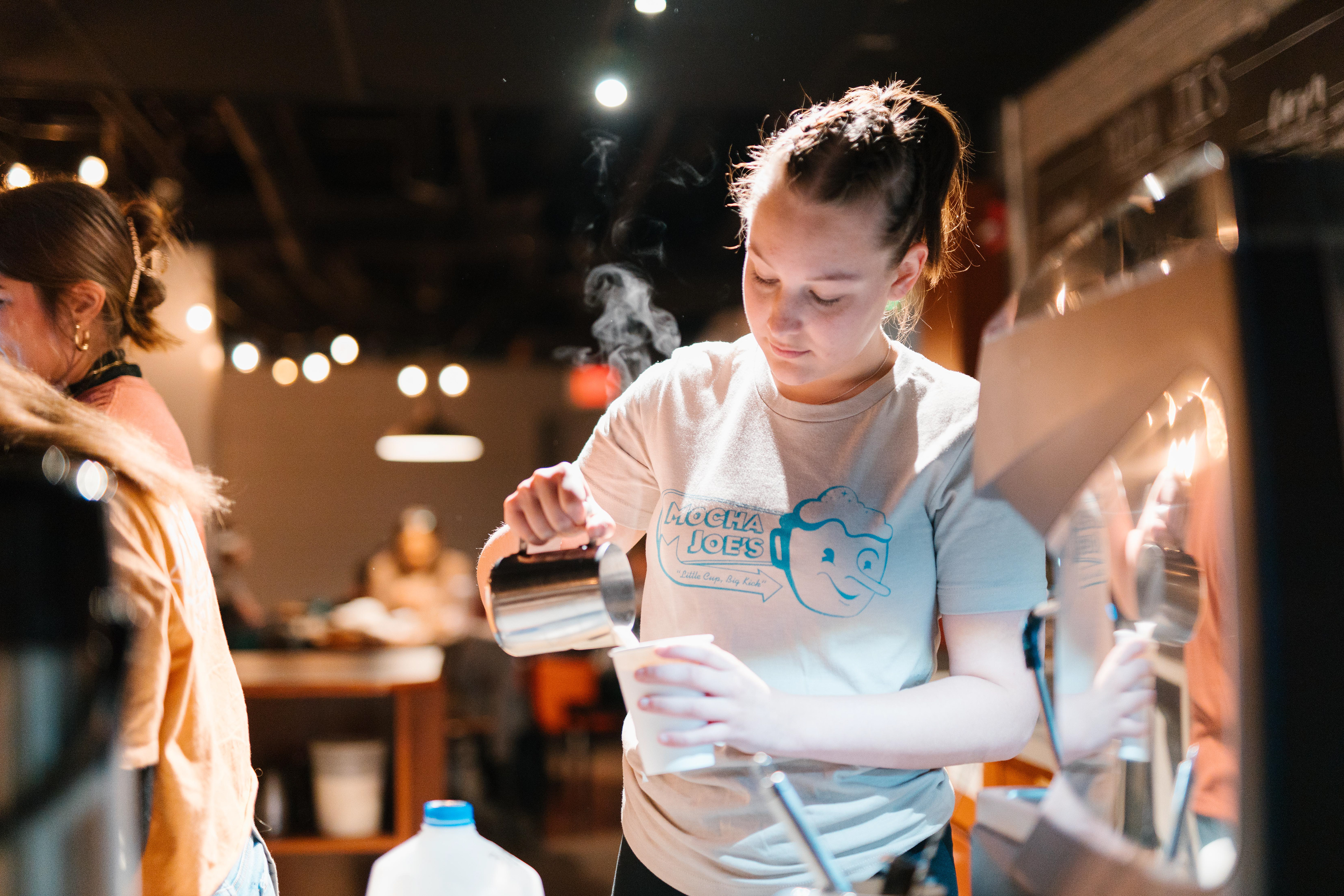 Lexi makes a drink promoting new tee-shirts