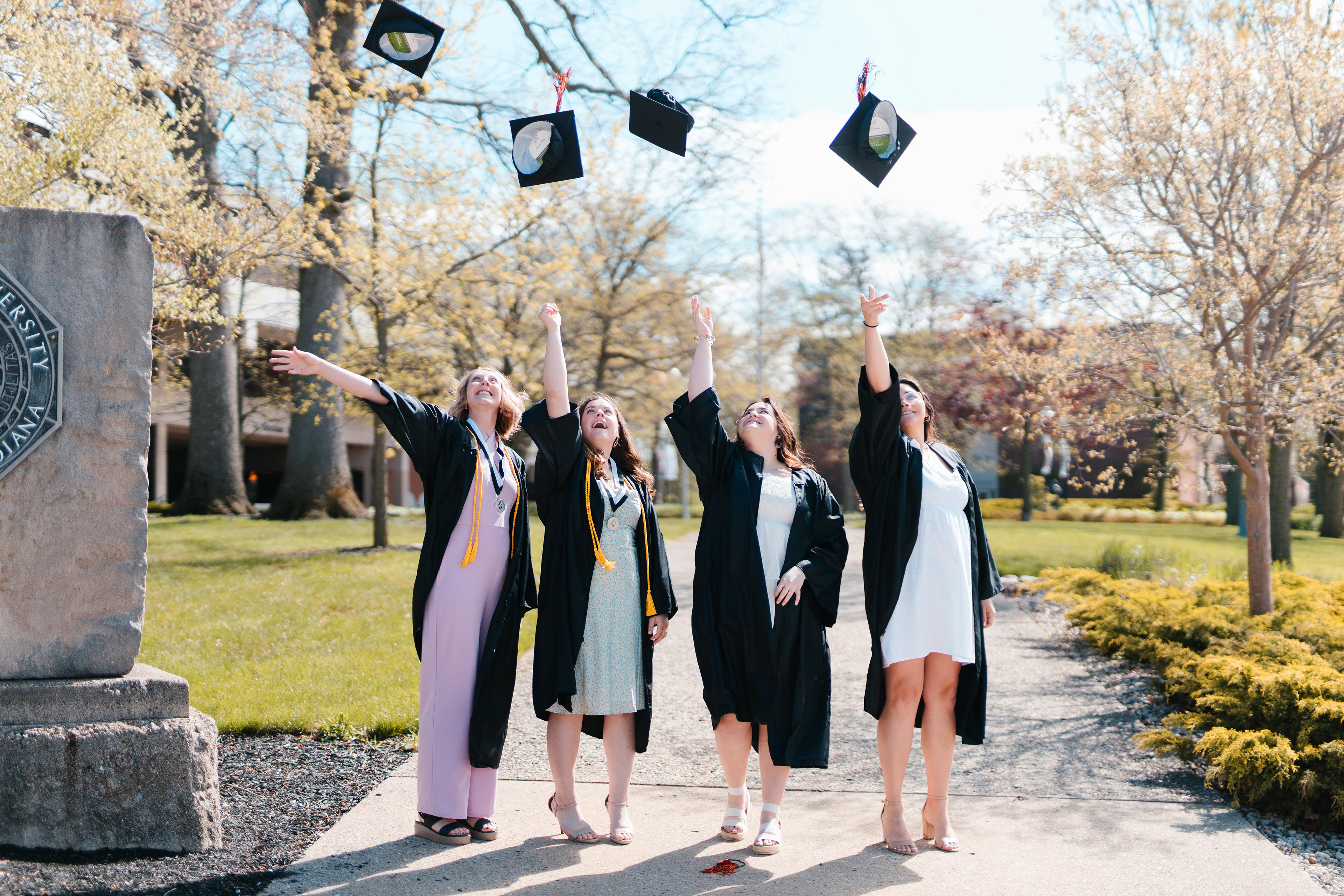 Graduating seniors toss their caps