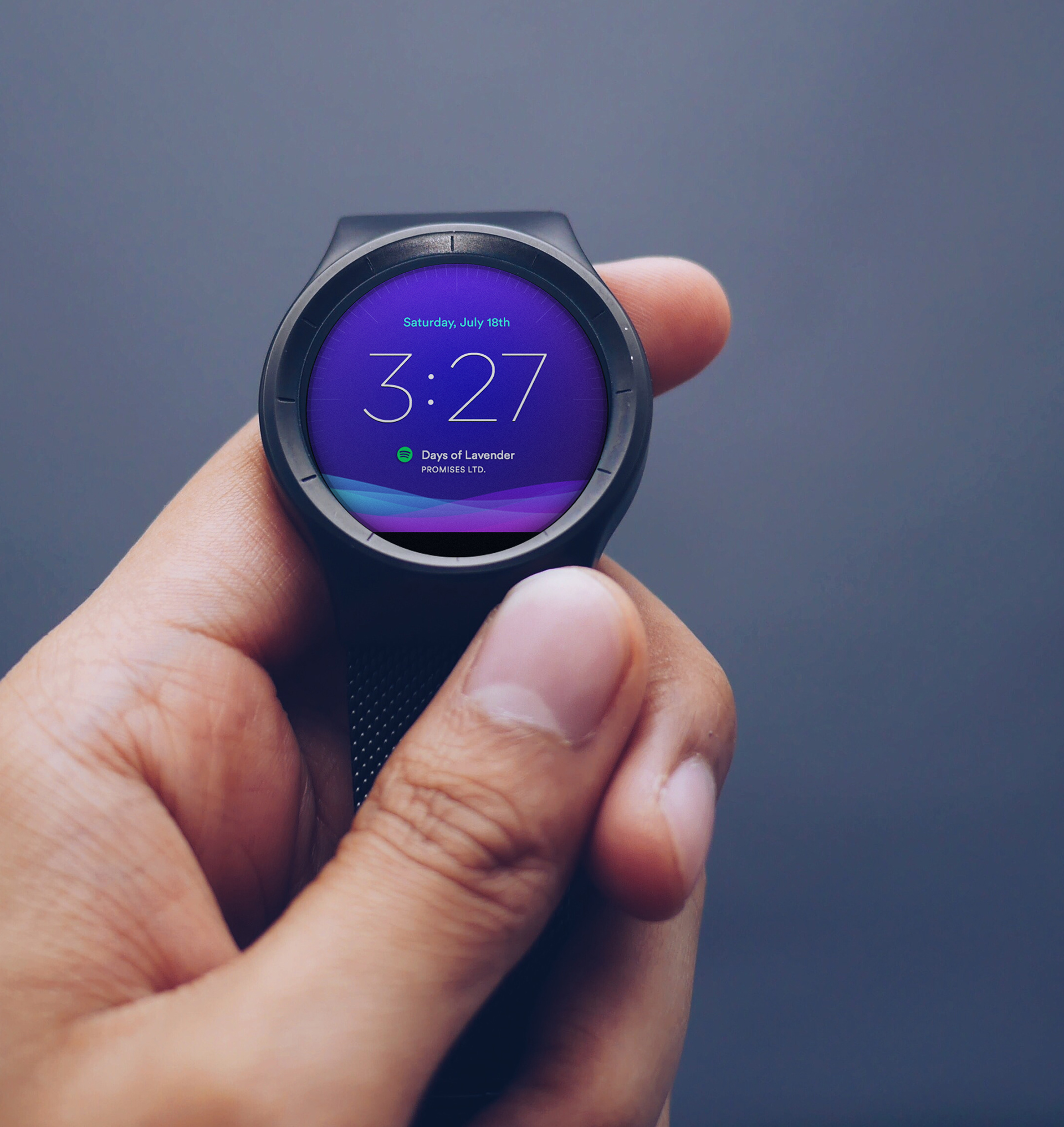 Man holding a Moto 360 showing the Android Wear Moto 360 watch face interface.