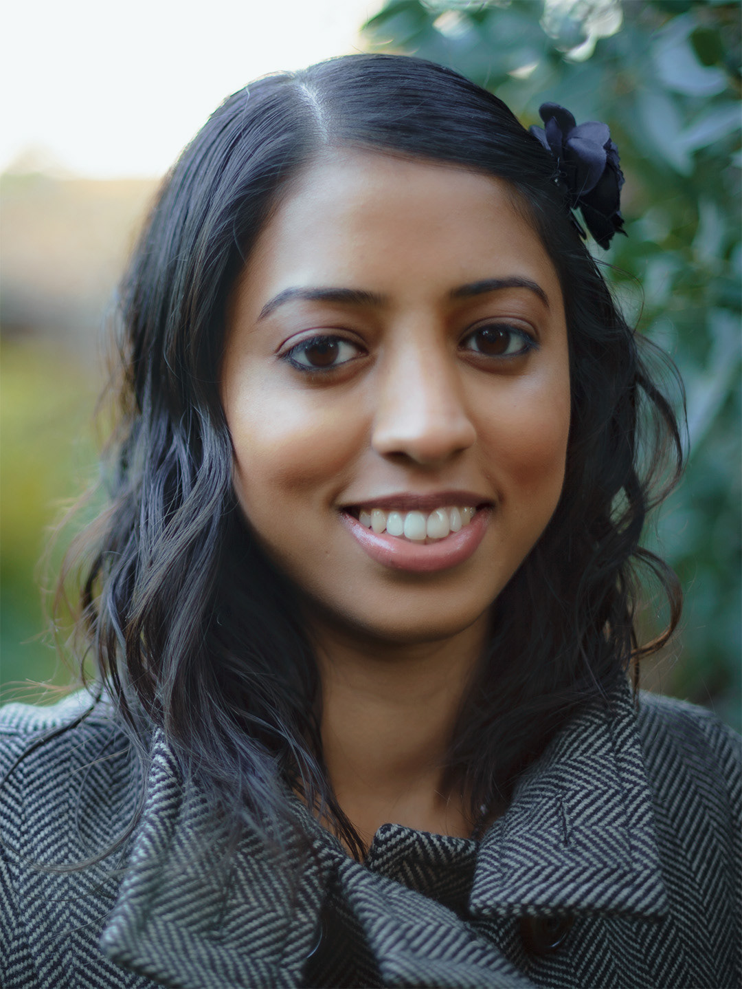 Portrait photograph of Anjna standing in an autumn scene