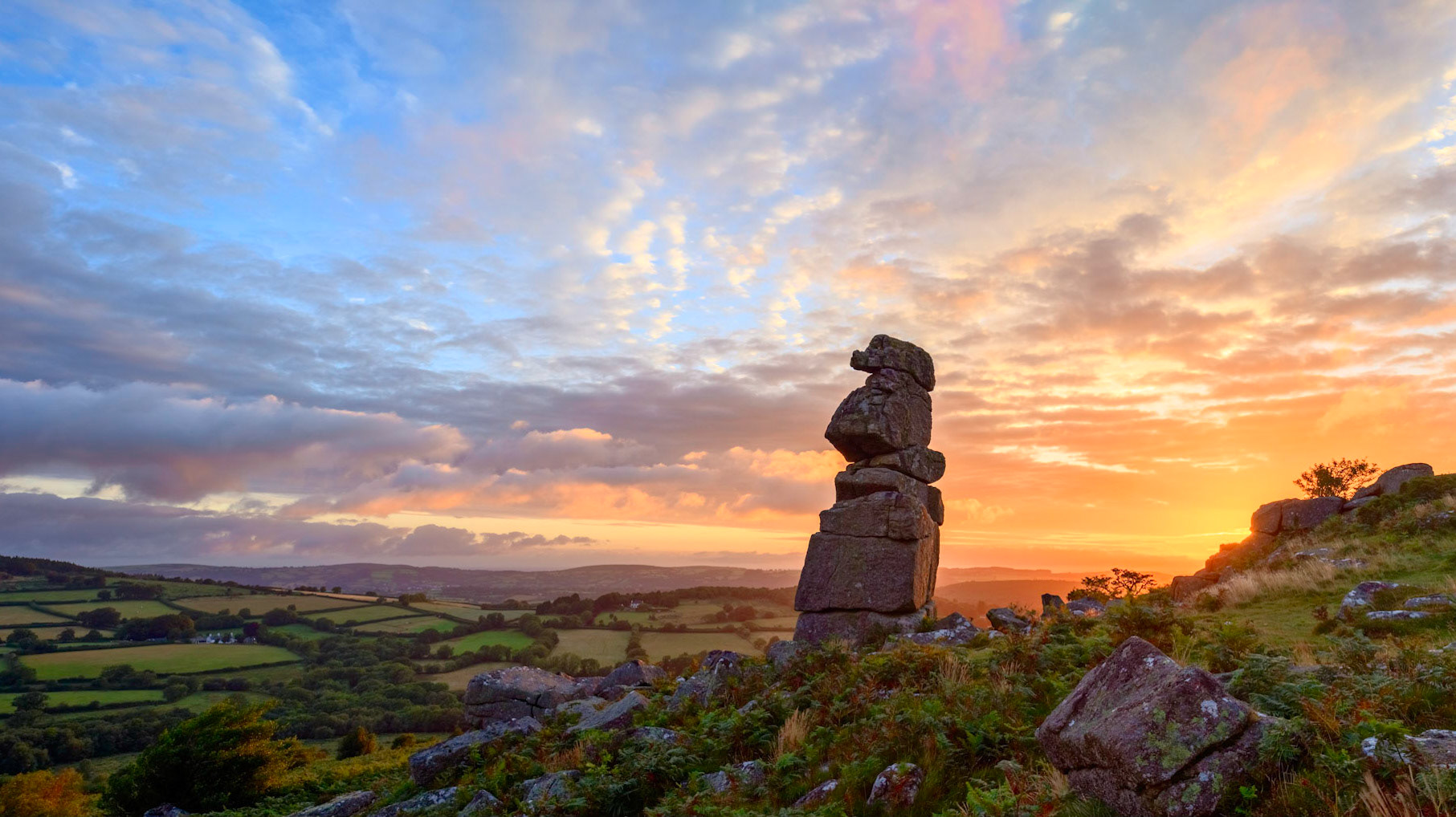 Sunrise behind Bowerman's nose rock formation on Southcott Down in Dartmoor National Park, Devon, UK.