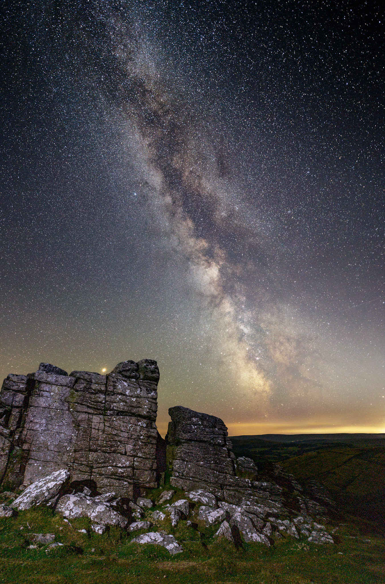 The Milky Way on a clear night sky over Hookney Tor in Dartmoor National Park.