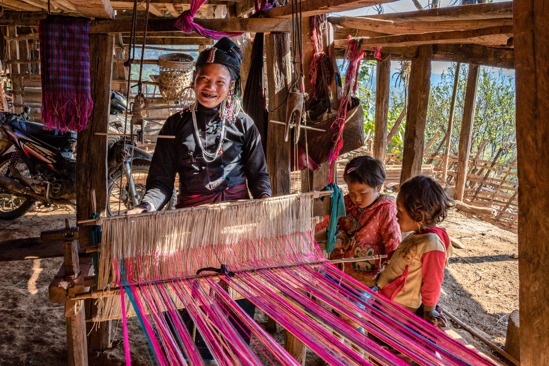 One of the women of the Ann tribe showing us how they weave fabric near Kwang Tung, Myanmar.