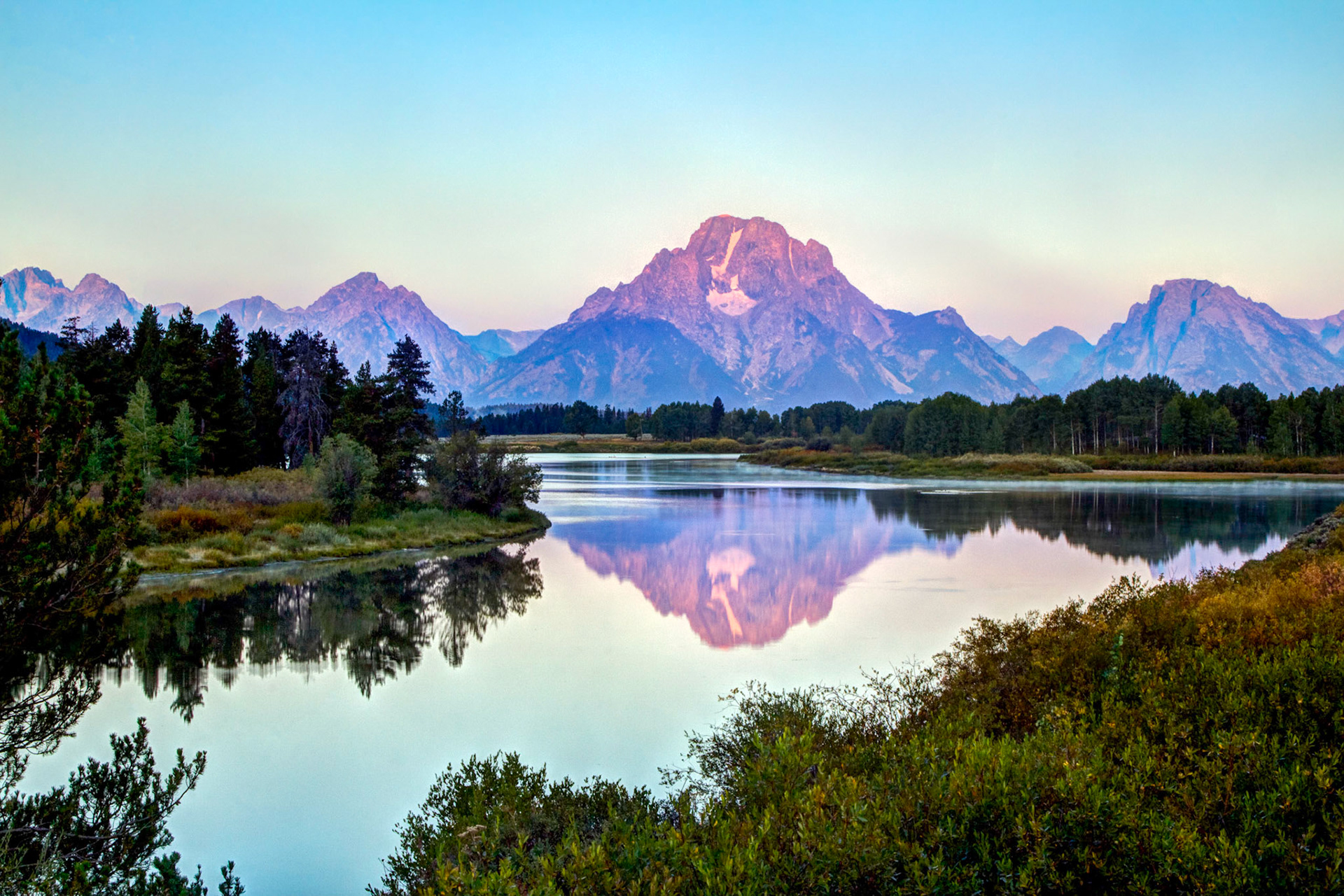 Oxbow bend in the Grand Teton National Park. Early morning at Oxbow bend watching the sun hit the mountains in the Grand Tetons Mountains. Mt Moran is the mountain in the middle with the Moran Glacier.