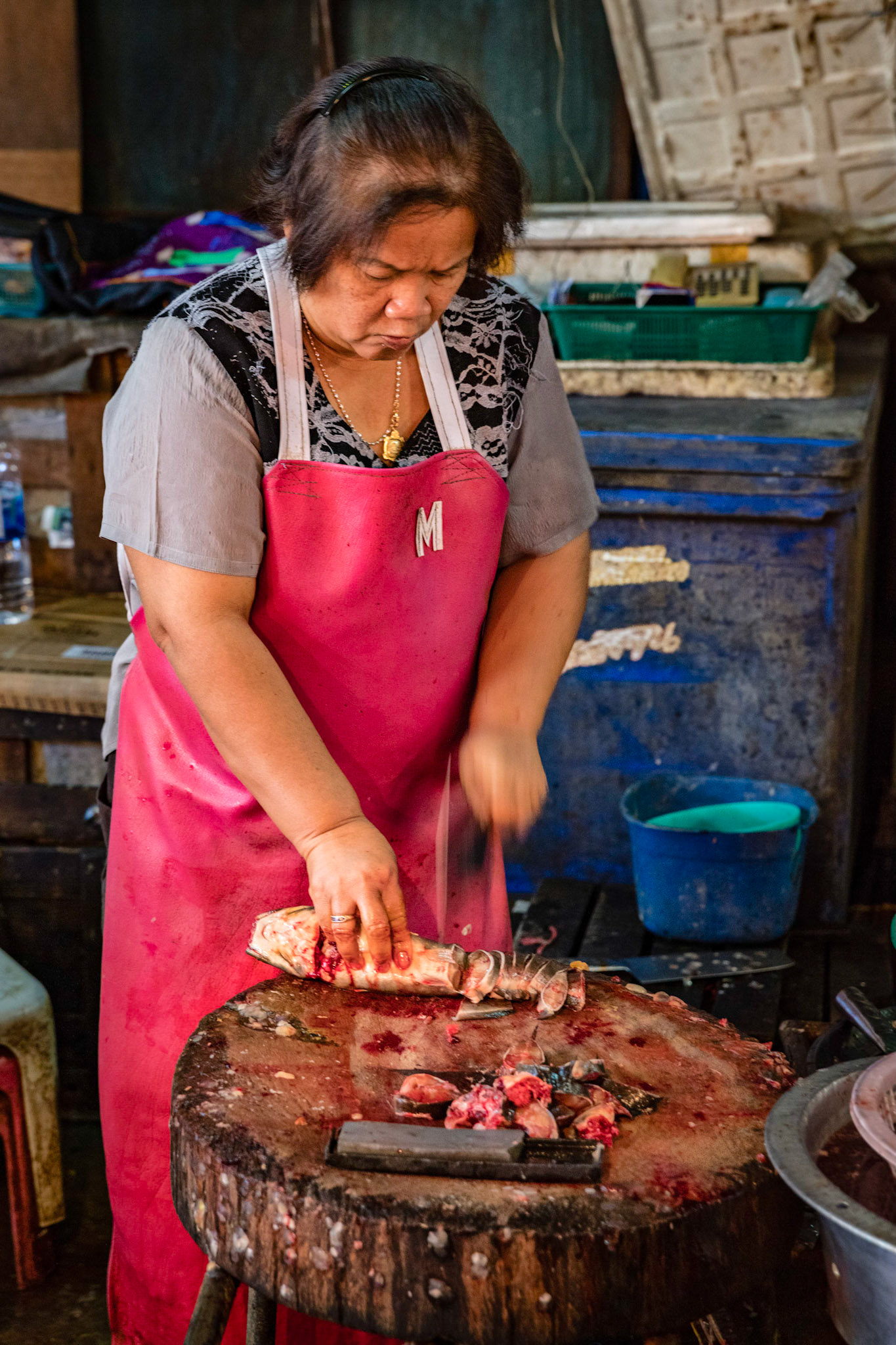 Woman chopping fish