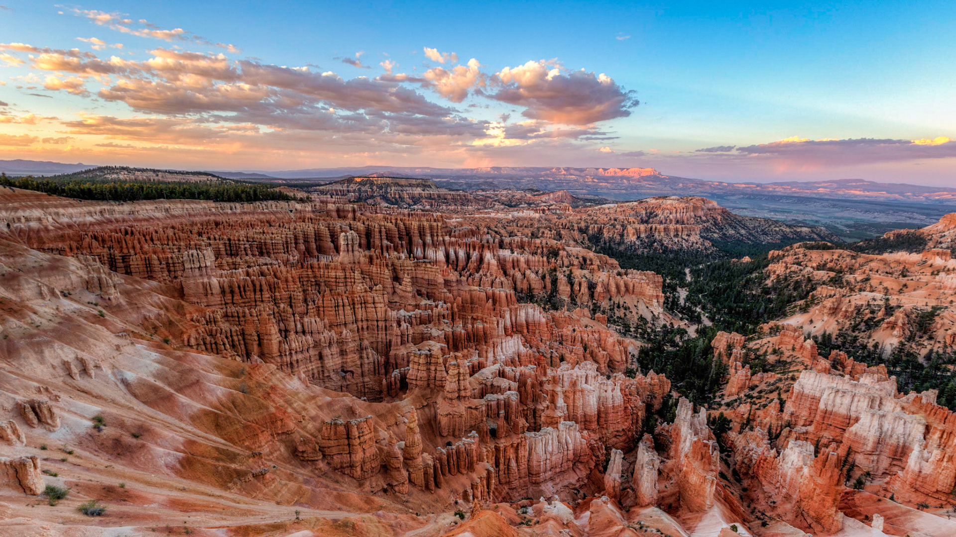 Sunset from Inspiration Point in Bryce Canyon National Park as the rain falls from the clouds never reaching the ground