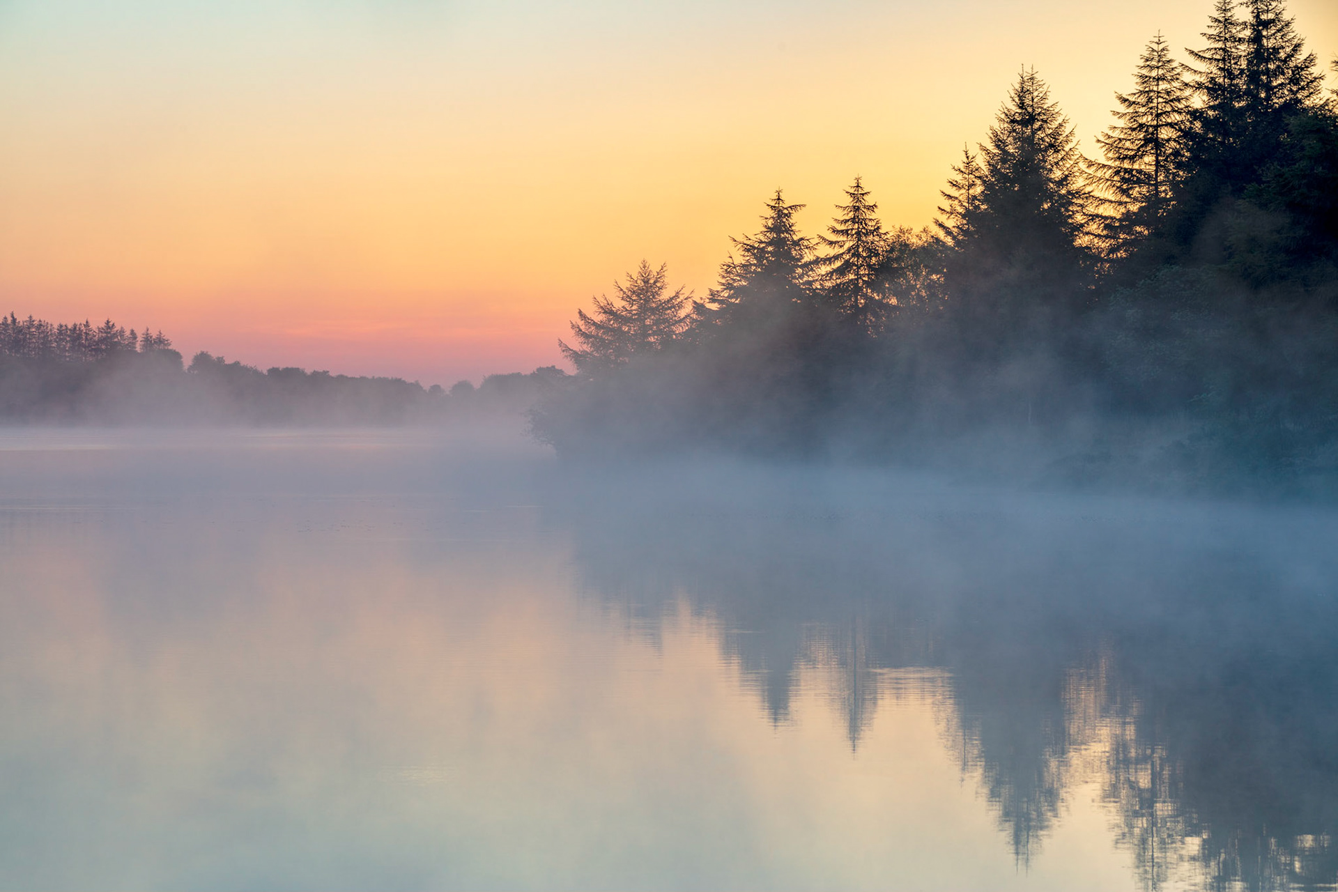 Early morning mist rising from Fernworthy Reservoir in Dartmoor National Park