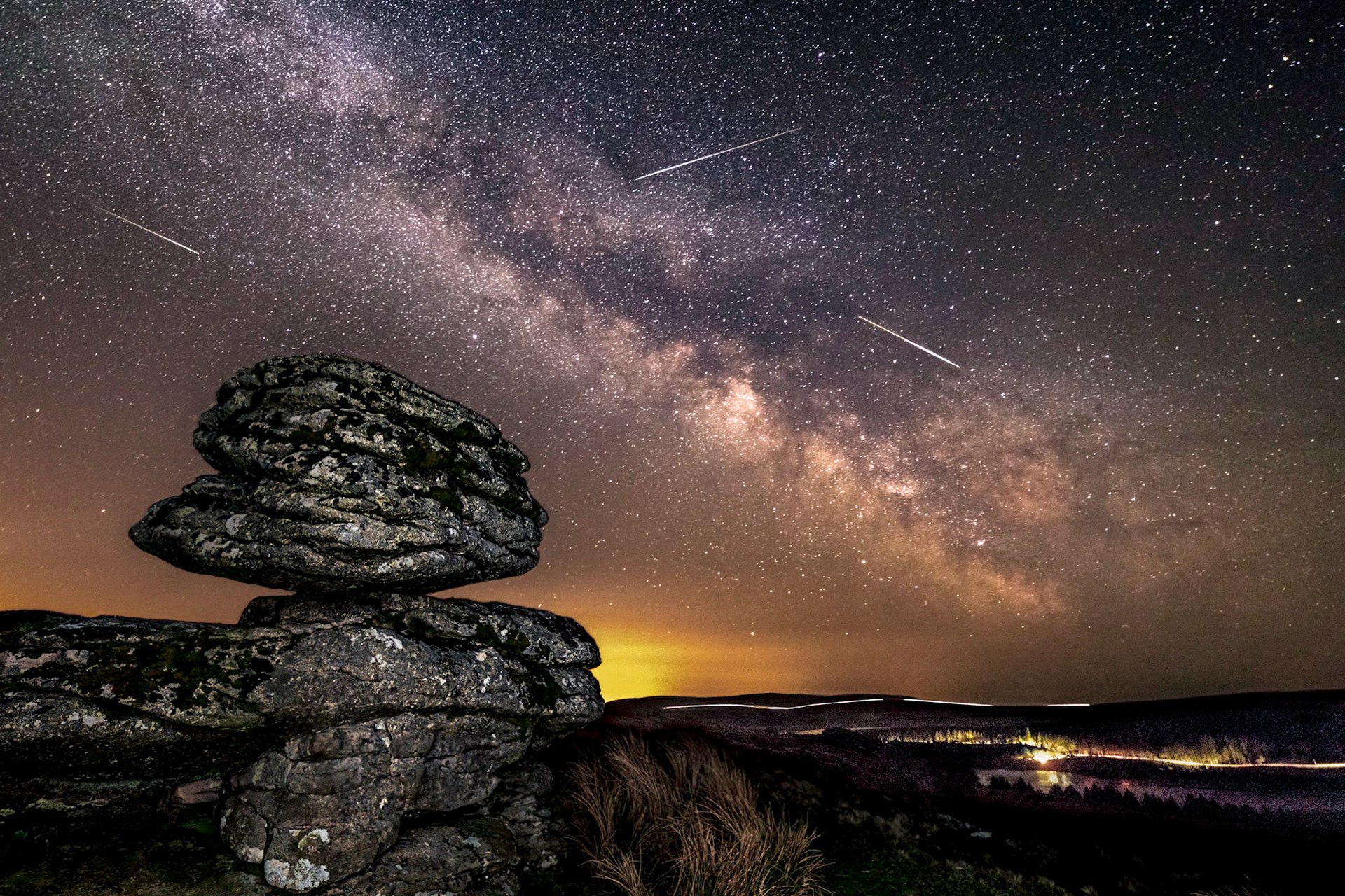 Meteors streaking across the sky from the Lyrid's Meteor Shower and the core of the Milky Way in the sky over Dartmoor national park, Devon, UK.