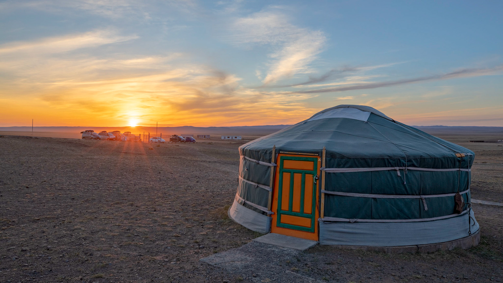 The orange sky of the setting sun at a ger camp in the Gobi desert.