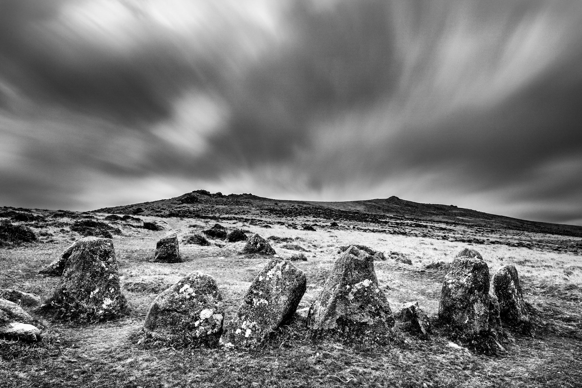 A blustery dark and moody morning with Nine Stones (Belstone) Stone Circle and Belstone tor.