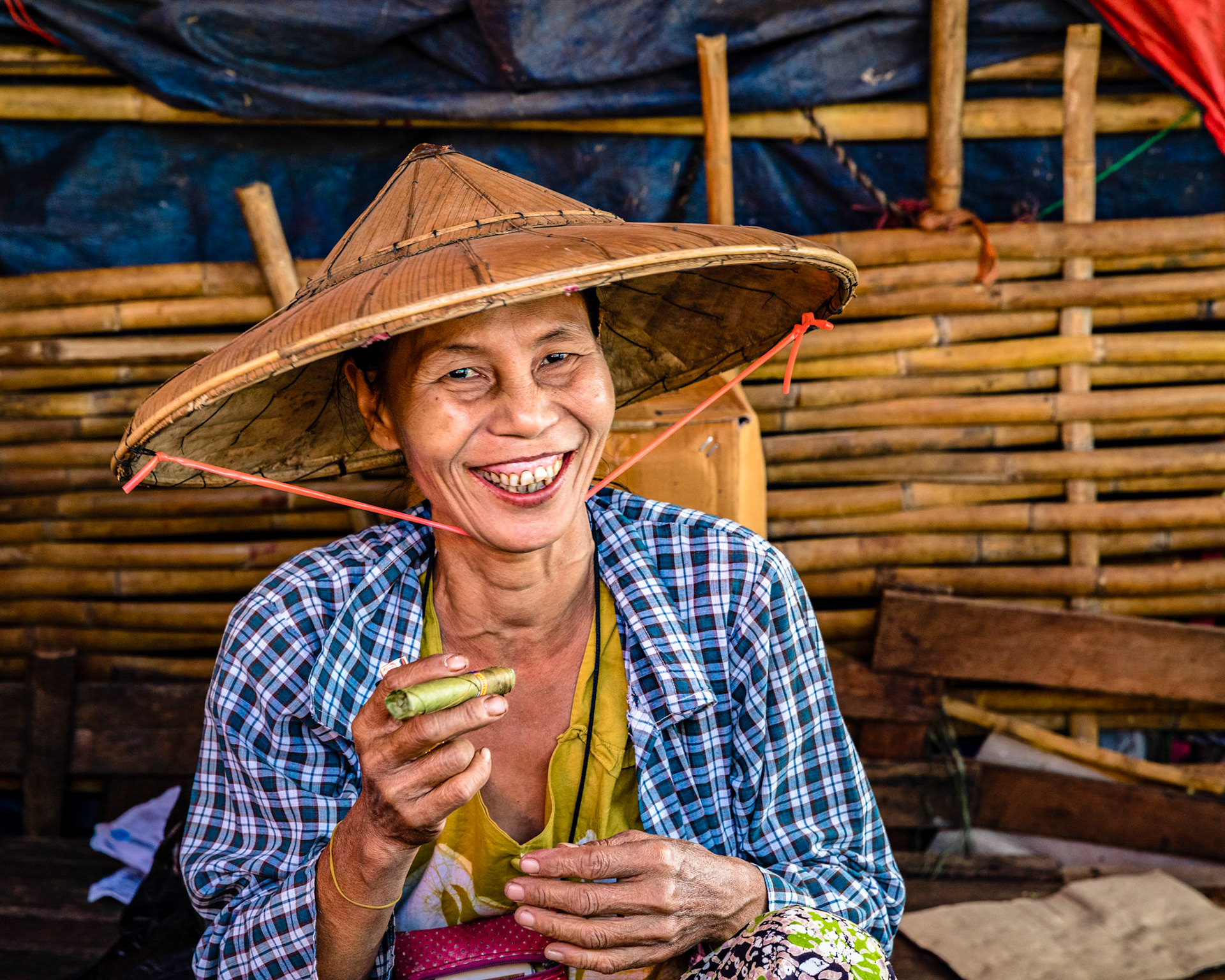 Burmese woman about to light her cigar at the Da Nyin Gone market in Yangon, Myanmar.