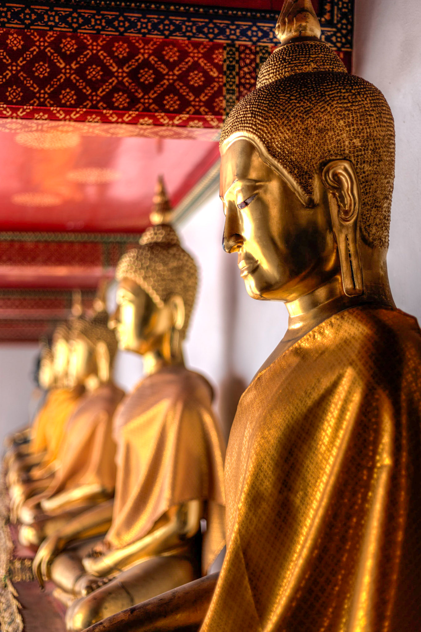 At Wat Pho in Bangkok looking at all of the budda's of varying styles and sizes.  This one is lite very nicely by the late afternoon light