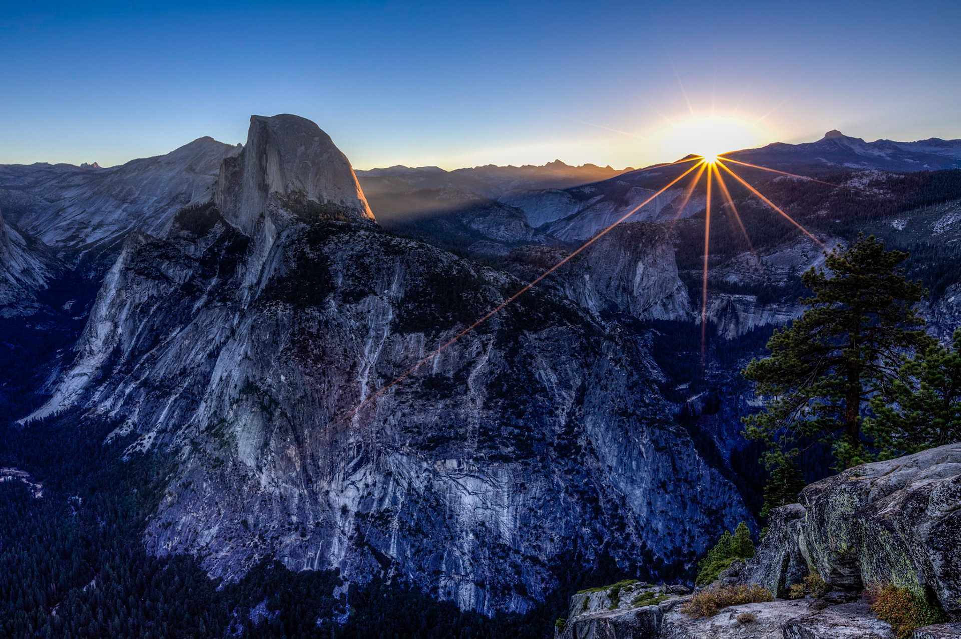 Sunrise at Glacier Point as the first light hits Half Dome and the other high Peaks