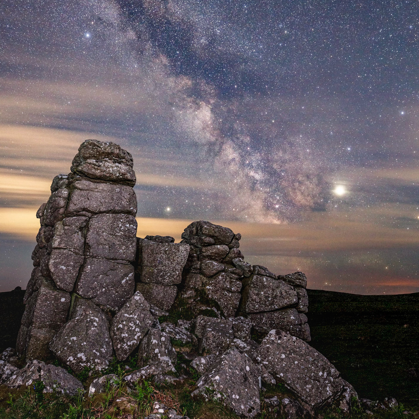 Clouds passing over Hounds Tor leave the most of the Milky Way visible.